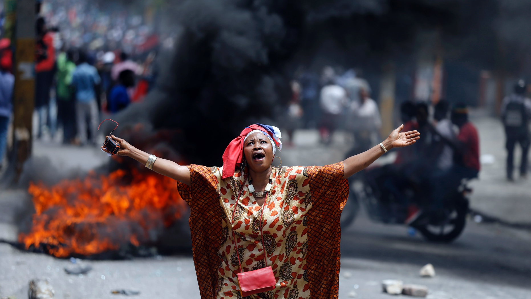 A protester yells anti-government slogans in Port-au-Prince, Haiti, Sunday, June 9, 2019. Protesters denouncing corruption paralyzed much of the capital as they demanded the removal of President Jovenel Moise. (AP Photo/Dieu Nalio Chery)