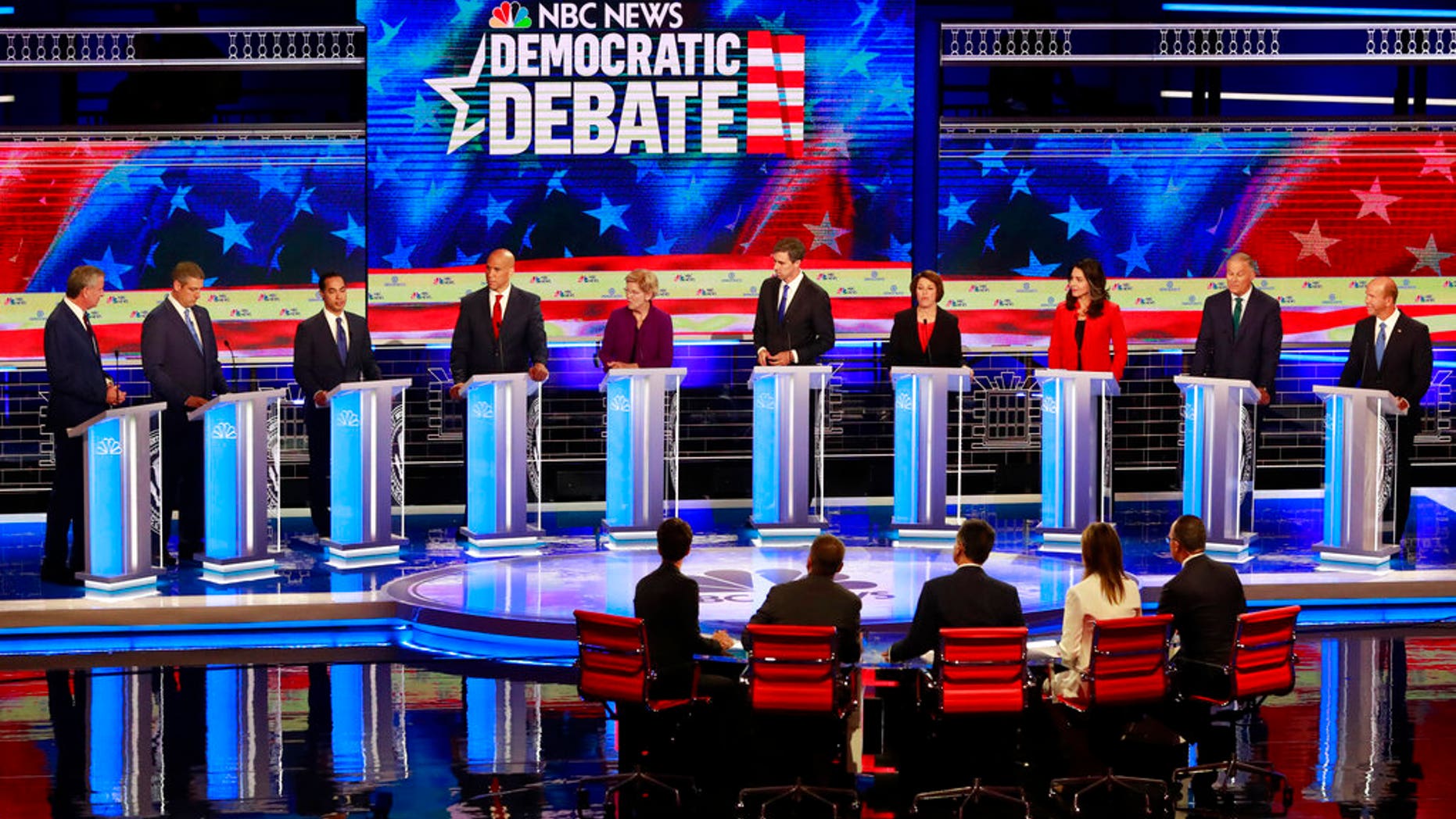 Democratic presidential candidate former Housing and Urban Development Secretary Julian Castro, third from left, answers a question, during a Democratic primary debate hosted by NBC News at the Adrienne Arsht Center for the Performing Art, Thursday, June 27, 2019, in Miami. (AP Photo/Wilfredo Lee)