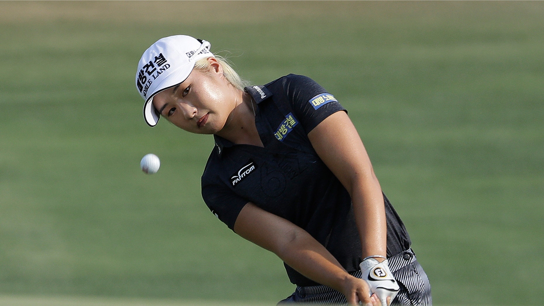 FILE - In this June 2, 2019, file photo, Jeongeun Lee6, of South Korea, chips to the 16th green during the final round of the U.S. Women's Open golf tournament, in Charleston, S.C. (AP Photo/Steve Helber, File)