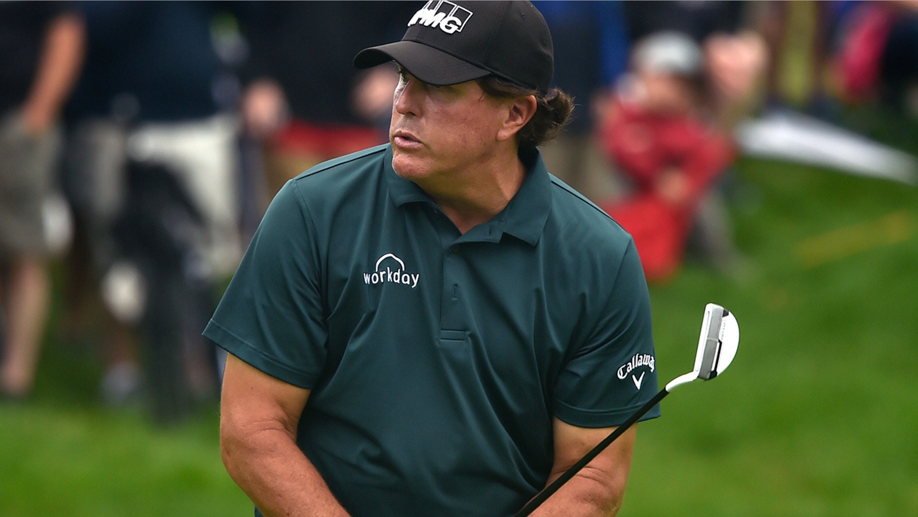 Phil Mickelson reacts to missing a birdie putt on the 9th green during first round play at the Travelers Championship golf tournament at TPC River Highlands, Thursday, June 20, 2019 in Cromwell, Conn.(Brad Horrigan/Hartford Courant via AP)