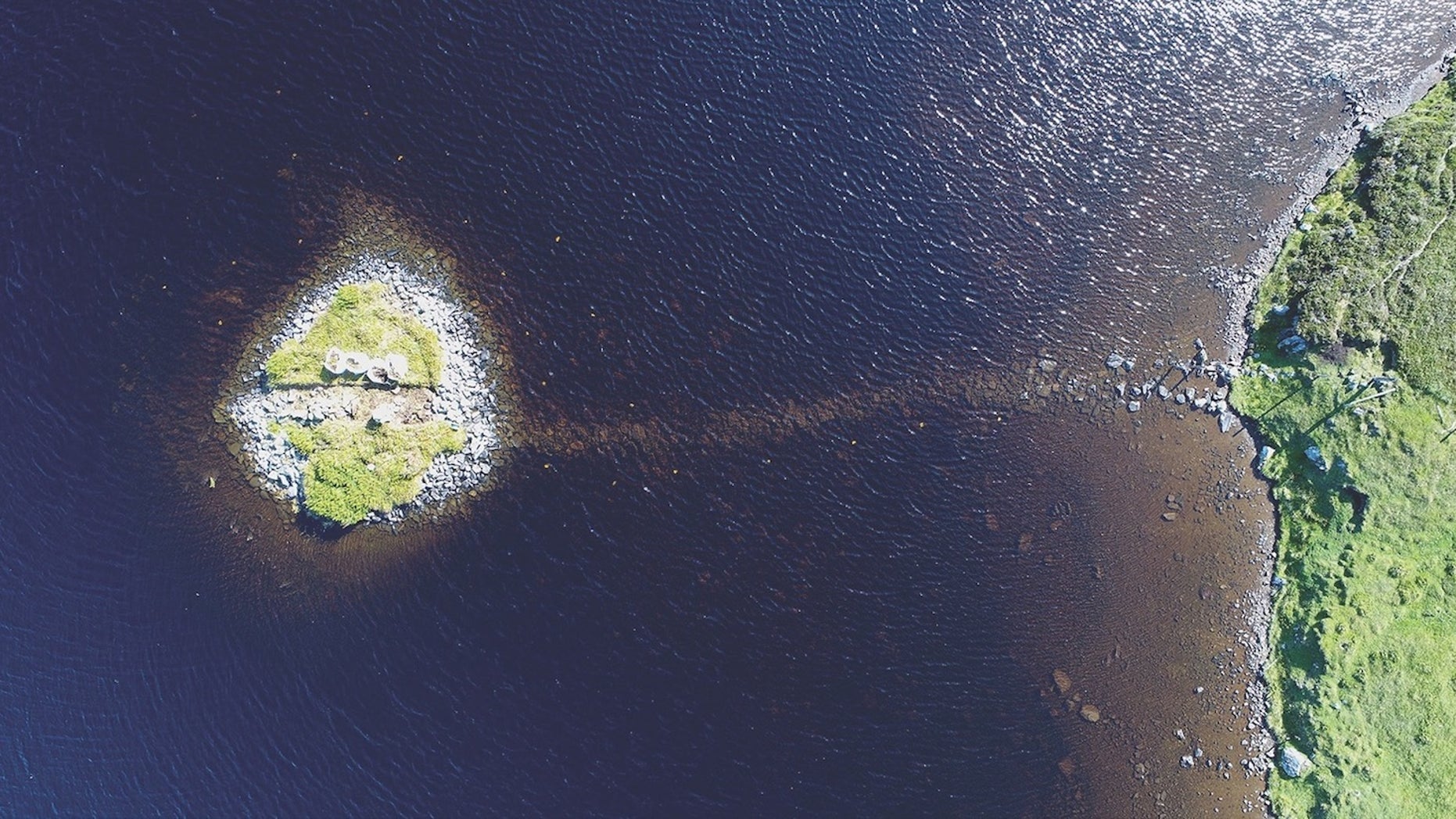 A bird's-eye view of Loch Bhorgastail, an islet that was clearly human-made with boulders.