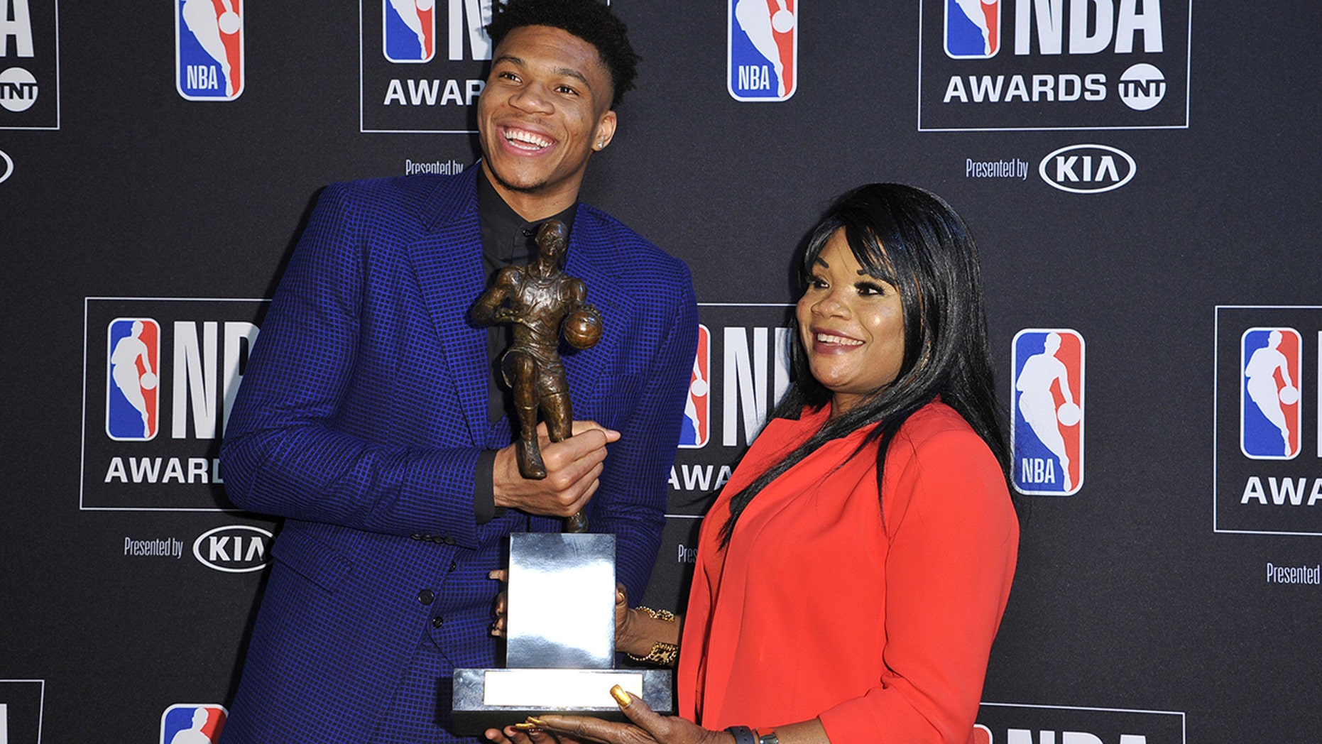 NBA player Giannis Antetokounmpo, of the Milwaukee Bucks, winner of the most valuable player award, left, and mother Veronica Antetokounmpo pose in the press room at the NBA Awards on Monday, June 24, 2019, at the Barker Hangar in Santa Monica, Calif. (Photo by Richard Shotwell/Invision/AP)