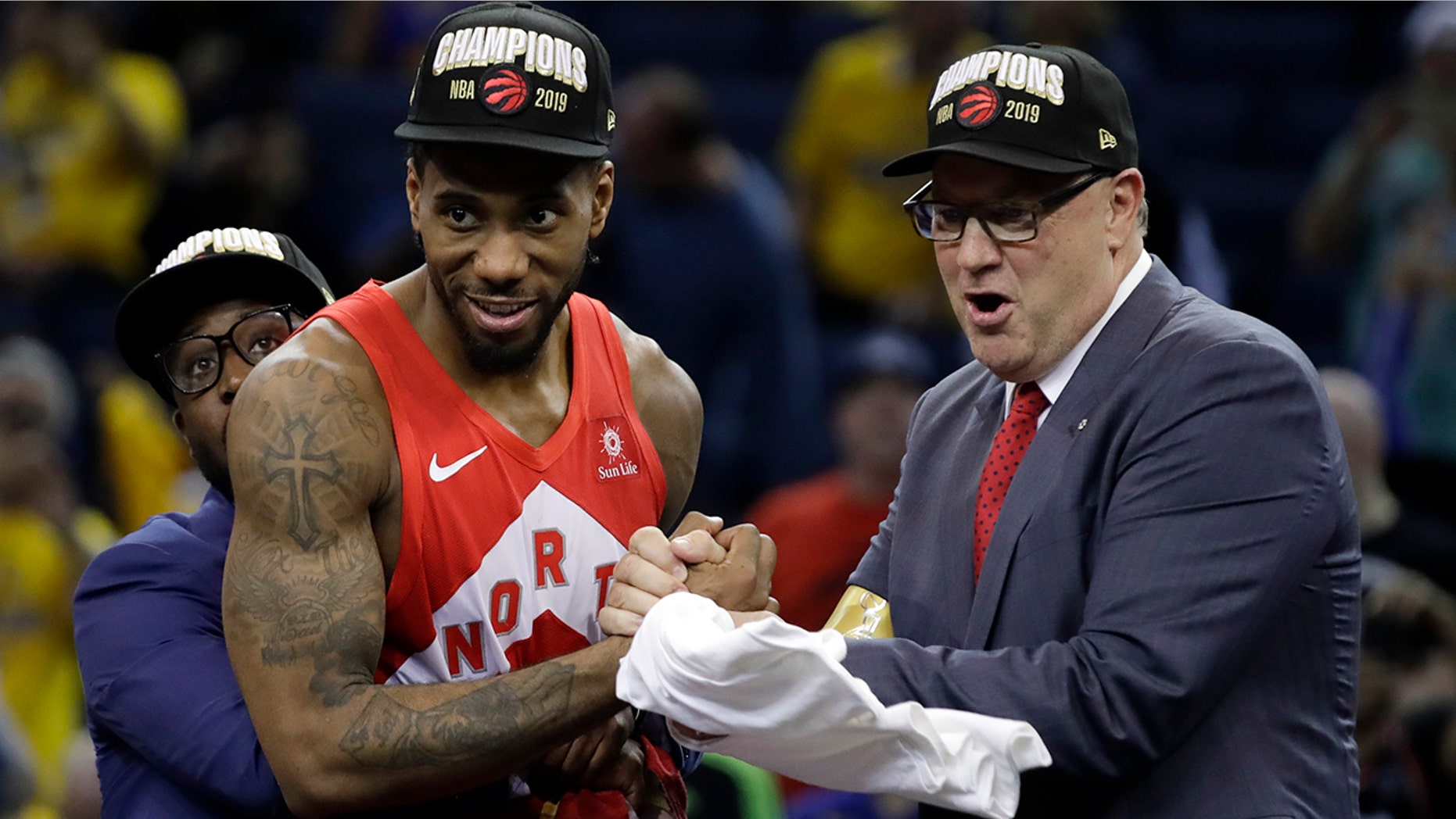 Toronto Raptors forward Kawhi Leonard, center, celebrates after the Raptors defeated the Golden State Warriors in Game 6 of basketball's NBA Finals in Oakland, Calif., Thursday, June 13, 2019. (AP Photo/Ben Margot)