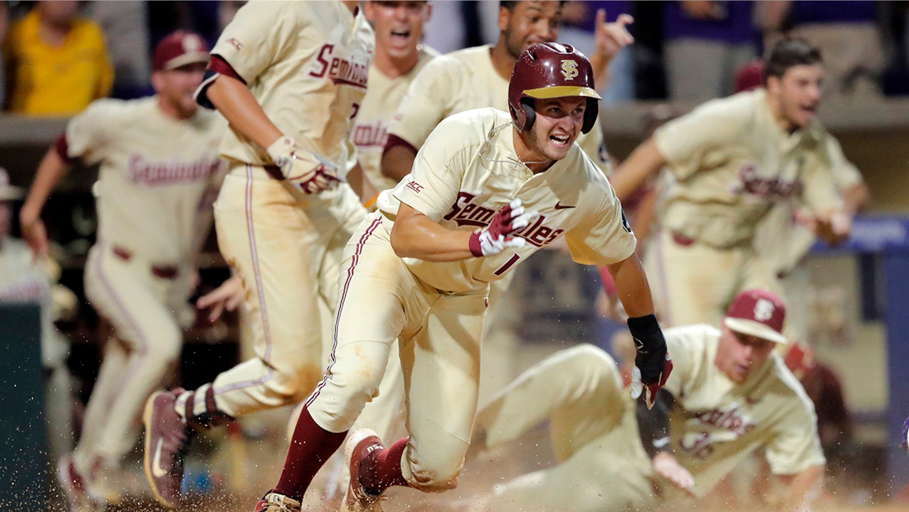 Florida State's Mike Salvatore reacts after crossing home plate to score the winning run against LSU in the 12th inning of Game 2 of the NCAA college baseball super regional tournament in Baton Rouge, La., Sunday, June 9, 2019. Florida State won 5-4 to advance to the College World Series. (AP Photo/Gerald Herbert)
