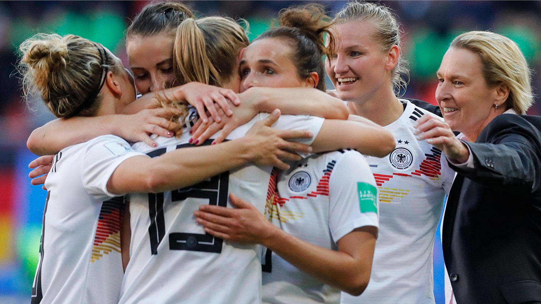 Germany head coach Martina Voss-Tecklenburg, right, celebrates with her players at the end of the Women's World Cup Group B soccer match between Spain and Germany at Stade du Hainau in Valenciennes, France, Wednesday, June 12, 2019. Germany won 1-0. (AP Photo/Michel Spingler)