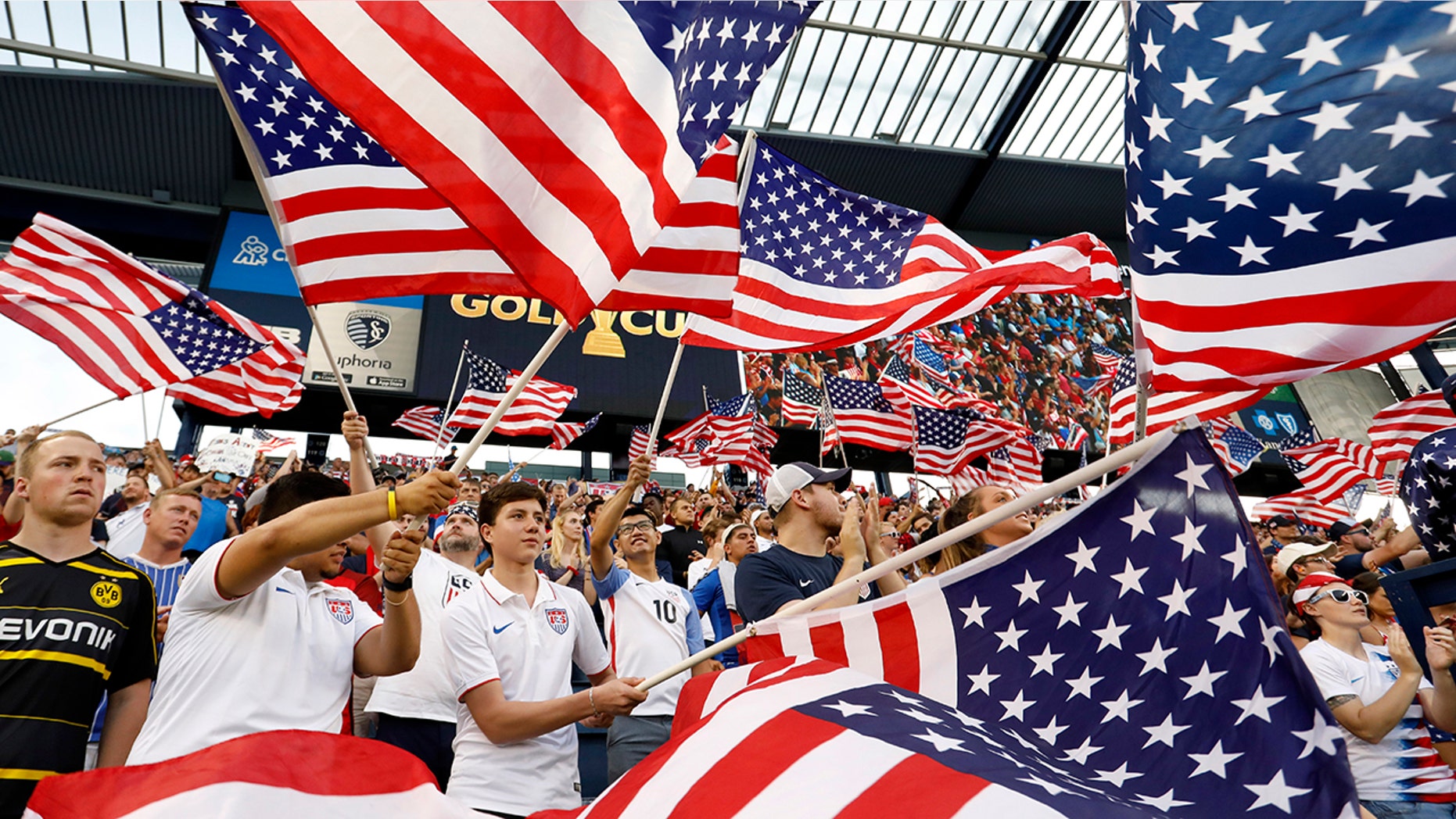 Fans of the U.S. team wave flags as the players are introduced for a CONCACAF Gold Cup soccer match against Panama in Kansas City, Kan., Wednesday, June 26, 2019. (AP Photo/Colin E. Braley)