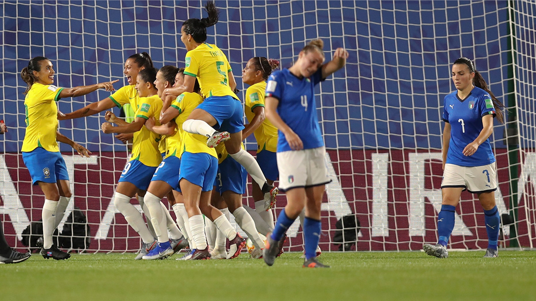 Brazil's Marta, left, celebrates after scoring her side's first goal with a penalty kick during the Women's World Cup Group C soccer match between Italy and Brazil at the Stade du Hainaut in Valenciennes, France, Tuesday, June 18, 2019. (AP Photo/Francisco Seco)