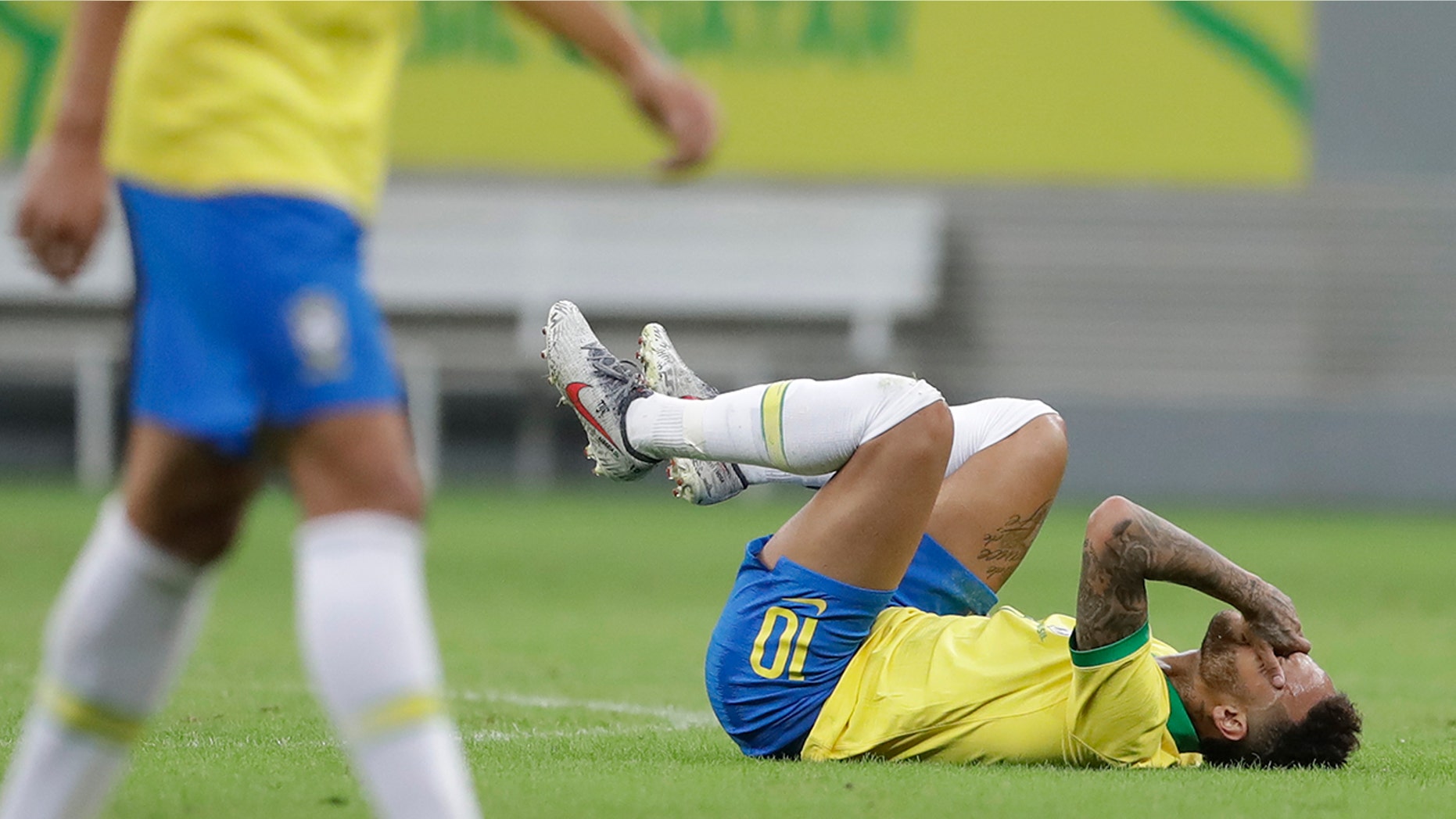 Brazil's Neymar lies on the pitch after being fouled during a friendly soccer match against Qatar at the Estadio Nacional in Brasilia, Brazil, Wednesday, June 5, 2019. Brazil and Qatar are preparing for the Copa America which runs from June 14 until July 7 in Brazil. (AP Photo/Andre Penner)