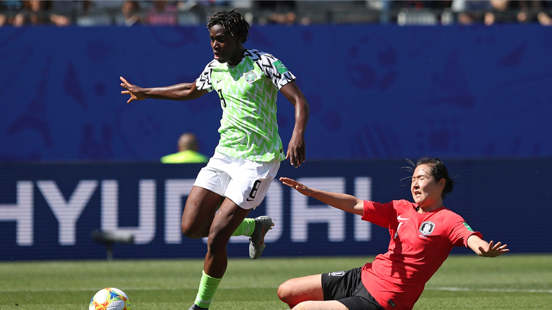 Nigeria's Asisat Oshoala gets away from South Korea's Hwang Bo-ram on her way to scoring her side's second goal during the Women's World Cup Group A soccer match between Nigeria and South Korea in Grenoble, France, Wednesday June 12, 2019.(AP Photo/Laurent Cipriani)