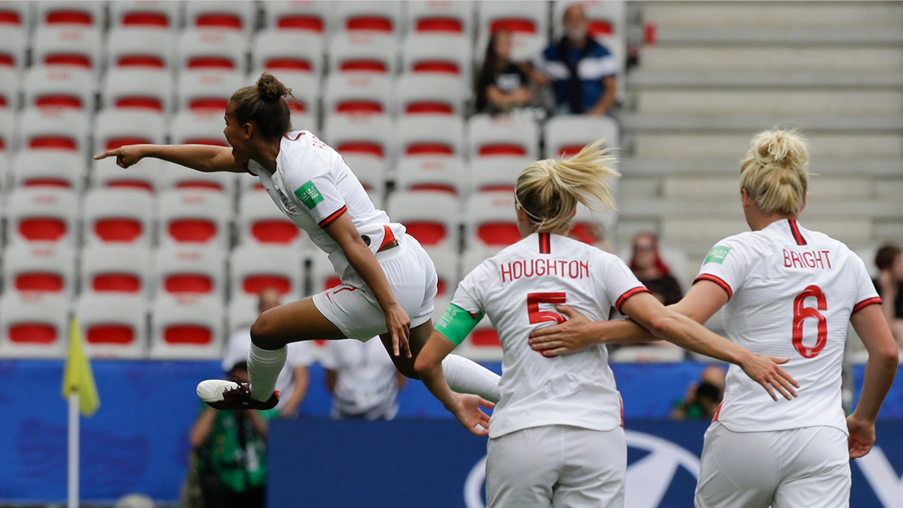 England's Nikita Parris, left, celebrates after scoring her side's opening goal on a penalty kick during the Women's World Cup Group D soccer match between England and Scotland in Nice, France, Sunday, June 9, 2019. (AP Photo/Claude Paris)