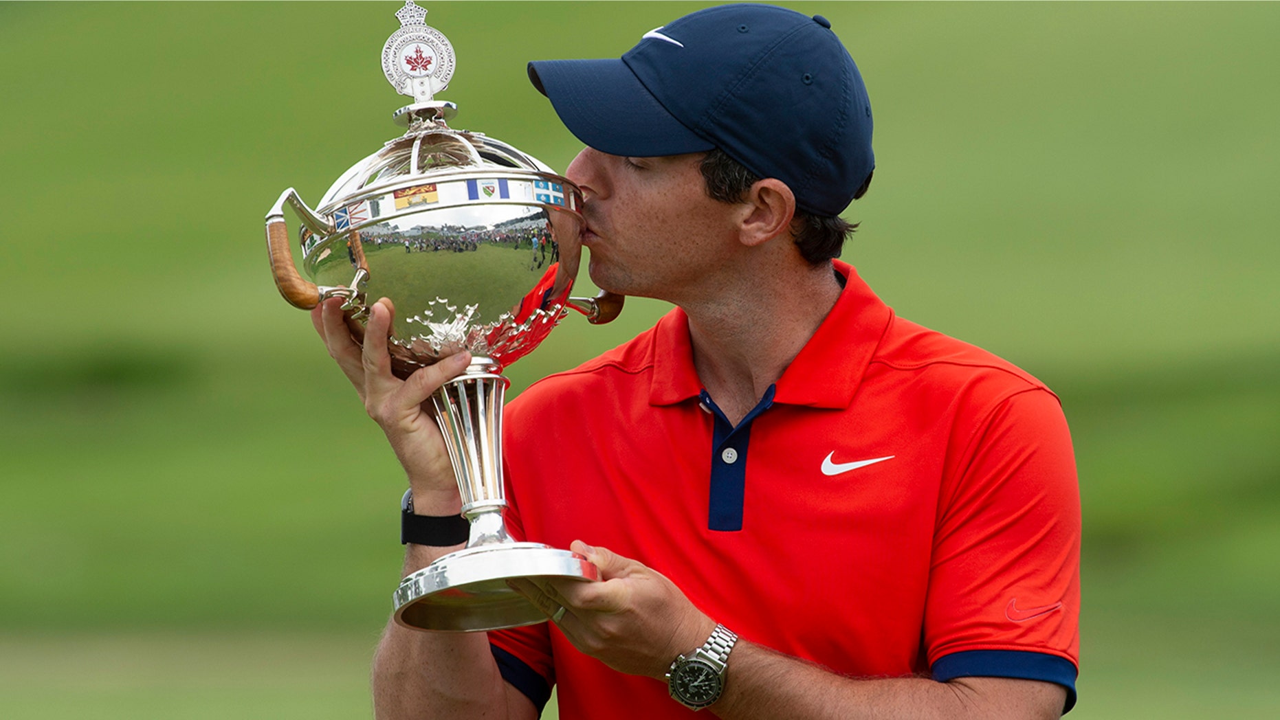Rory McIlroy kisses the trophy after winning the Canadian Open golf championship in Ancaster, Ontario, Sunday, June 9, 2019. (Adrian Wyld/The Canadian Press via AP)