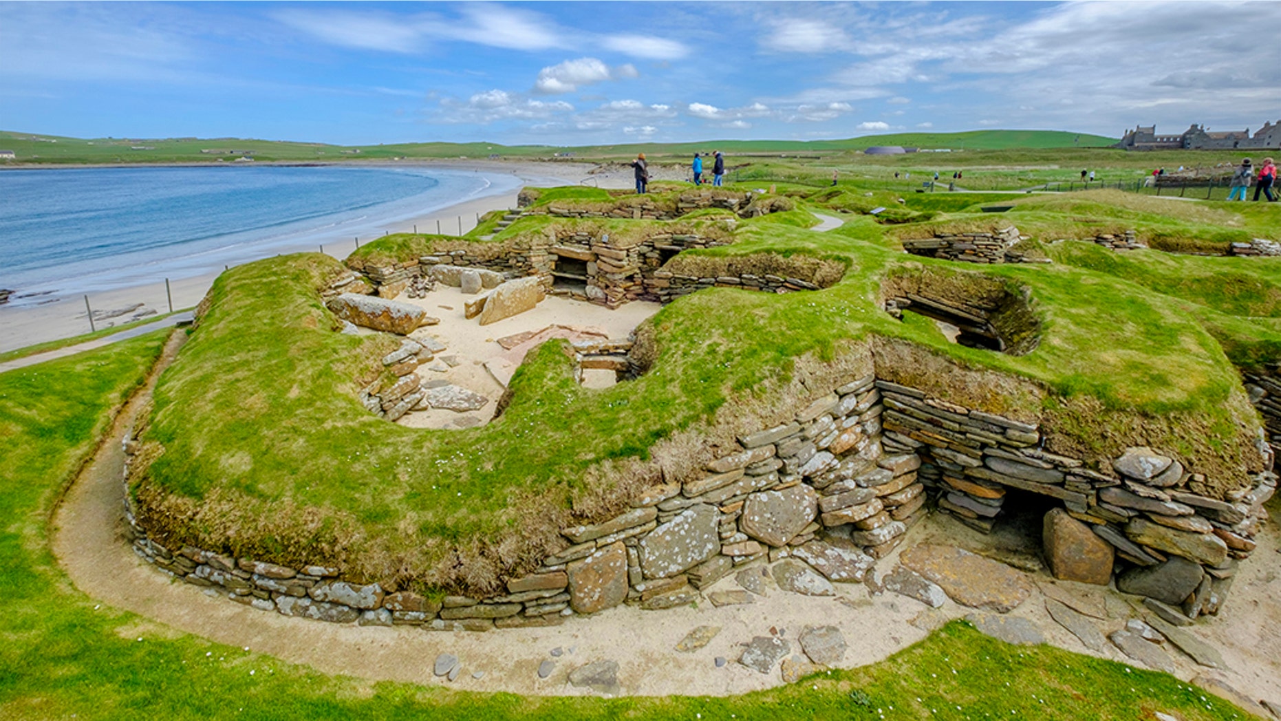 Tourists visiting Skara Brae, a Neolithic settlement located in the Mainland Orkney. In this prehistoric village, one of the best preserved groups of prehistoric houses in Western Europe, people can see the way of life of 5,000 years ago, before Stonehenge was built. (Credit: iStock)