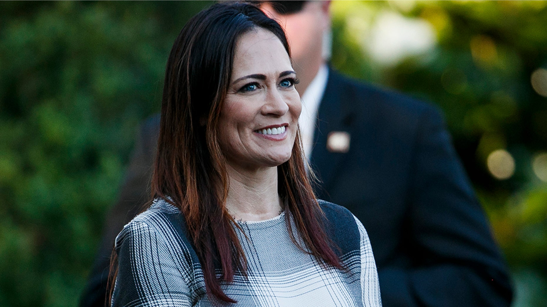 Stephanie Grisham, spokeswoman for first lady Melania Trump, watches as President Donald Trump and the first lady greet attendees during the annual Congressional Picnic on the South Lawn, Friday, June 21, 2019, in Washington. (AP Photo/Jacquelyn Martin)