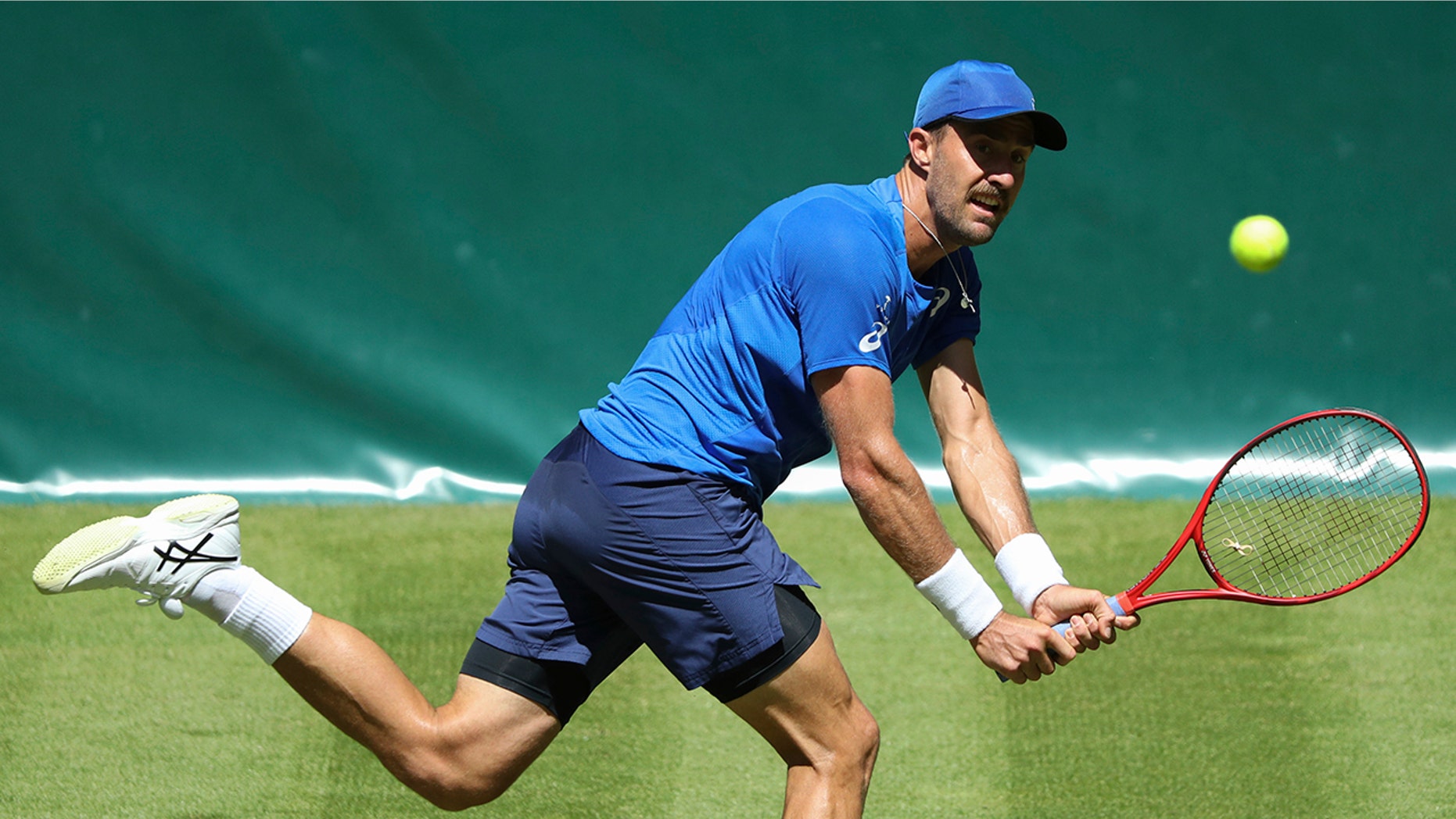 Steve Johnson from United States returns the ball to Germany's Philipp Kohlschreiber during their first round mat at the ATP tennis tournament in Halle Westphalia, Germany, Monday, June 17, 2019. (Friso Gentsch/dpa via AP)
