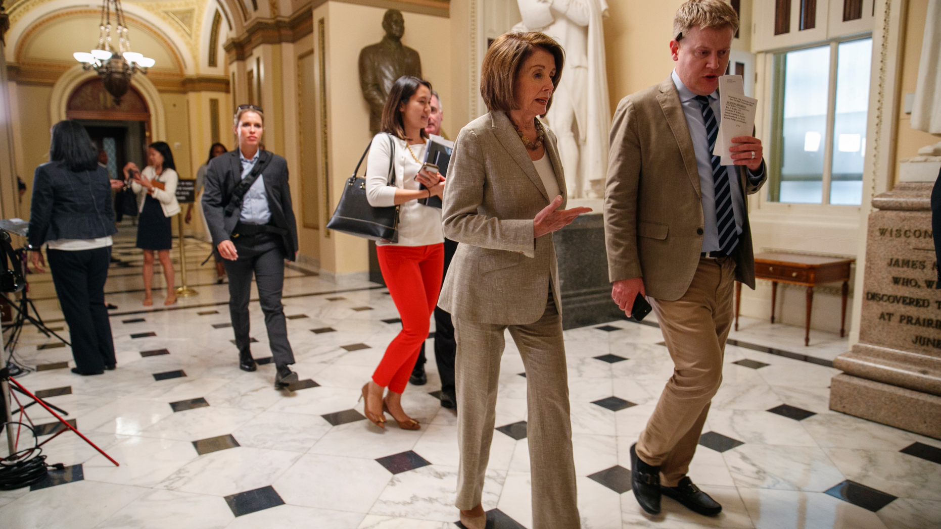 House Speaker Nancy Pelosi of Calif., second from right, leaves the House chamber, Monday June 3, 2019, on Capitol Hill in Washington, after the House voted to approve a $19 billion disaster aid bill, breaking a conservative blockade and sending the measure to President Trump, who is expected to sign it. (AP Photo/Jacquelyn Martin)