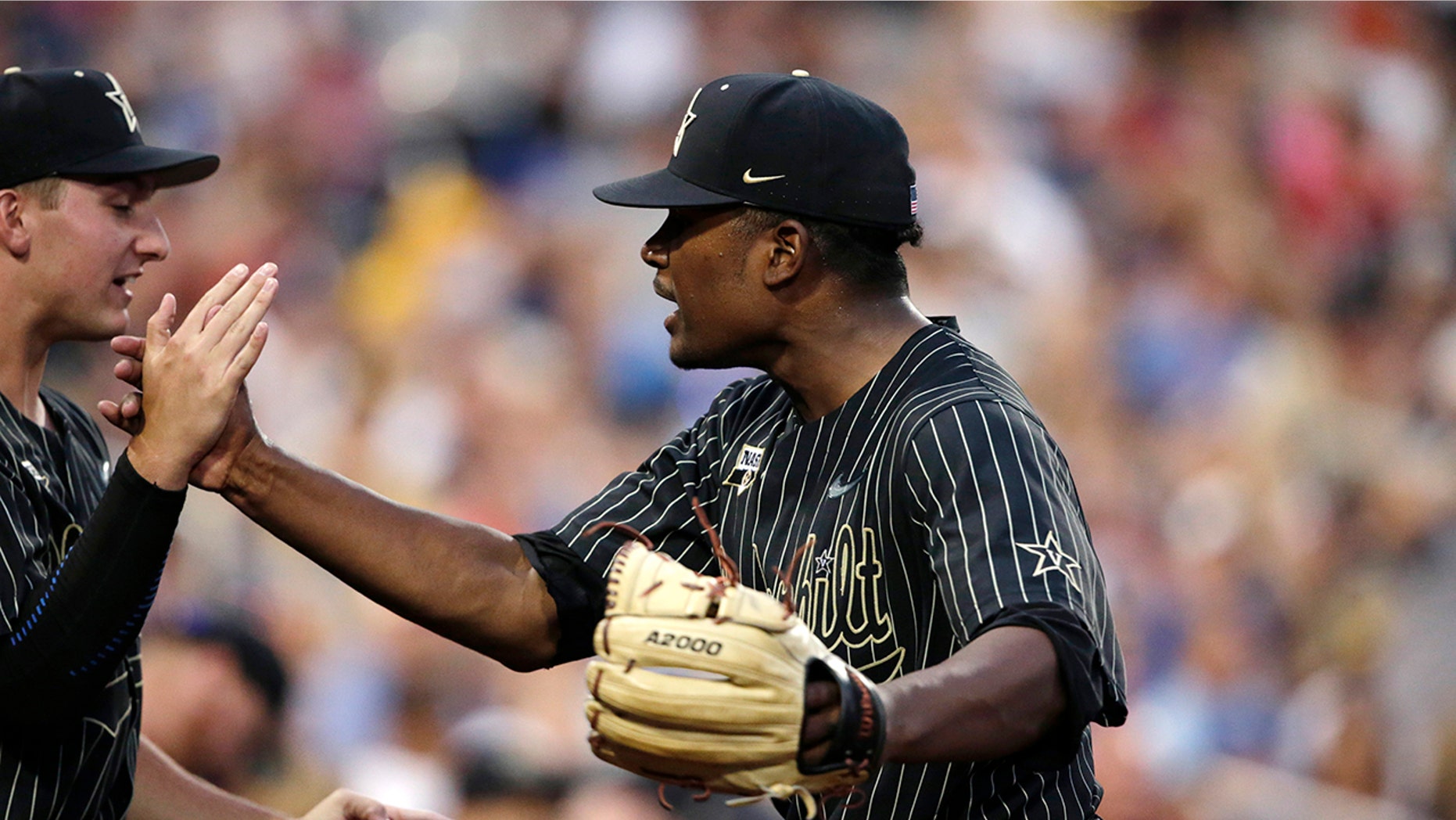 Vanderbilt pitcher Kumar Rockeer reacts at the end of the sixth inning against Michigan in Game 2 of the NCAA College World Series baseball finals in Omaha, Neb., Tuesday, June 25, 2019. (AP Photo/Nati Harnik)