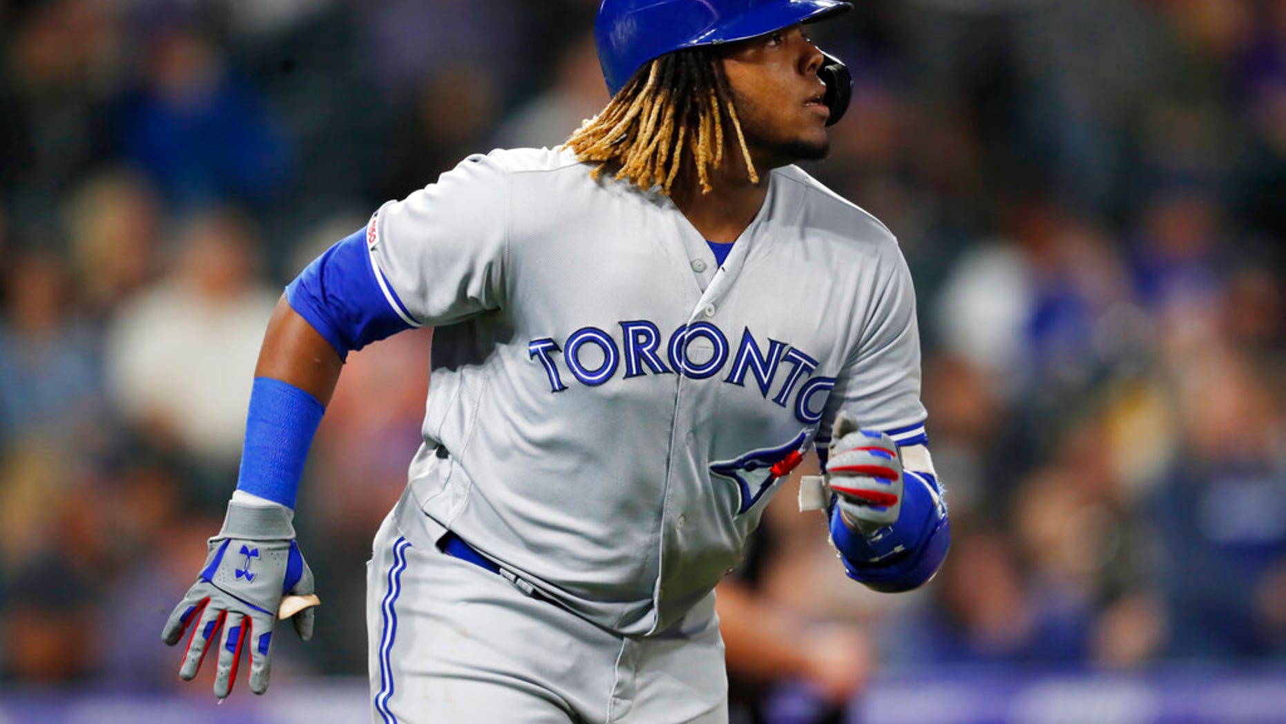 Toronto Blue Jays' Vladimir Guerrero Jr. heads up the first base line after hitting a solo home run off Colorado Rockies relief pitcher Chris Rusin during the eighth inning of a baseball game Friday, May 31, 2019, in Denver. (AP Photo/David Zalubowski)
