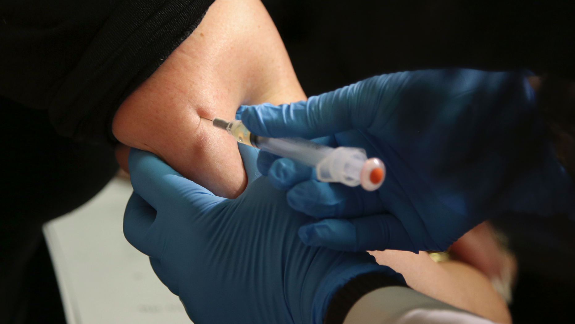FILE - In this March 27, 2019 file photo, a woman receives a measles, mumps and rubella vaccine at the Rockland County Health Department in Pomona, N.Y., north of New York City. On Wednesday, June 5, 2019, federal health officials updated the U.S. measles case count, saying 1,001 illnesses have been reported since the beginning of the year. (AP Photo/Seth Wenig)