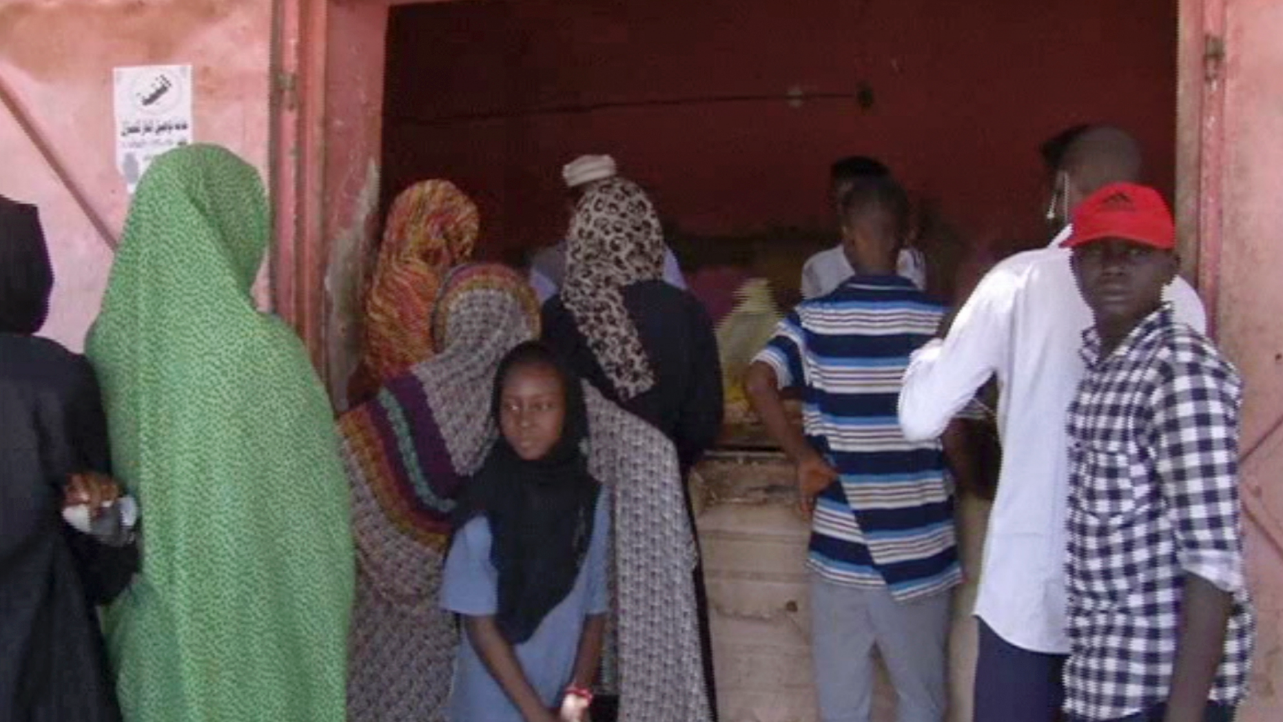 In this frame grab from video, people wait in line for bread outside a bakery in Khartoum, Sudan, Sunday, June 9, 2019. The first day of the workweek in Sudan saw shops closed and streets empty as part of a general strike called by protest leaders who are demanding the resignation of the ruling military council. The Sudanese Professionals Association had urged people to stay home to protest a deadly crackdown last week, when security forces violently dispersed the group’s main sit-in camp outside the military headquarters in the capital of Khartoum. (AP Photo)