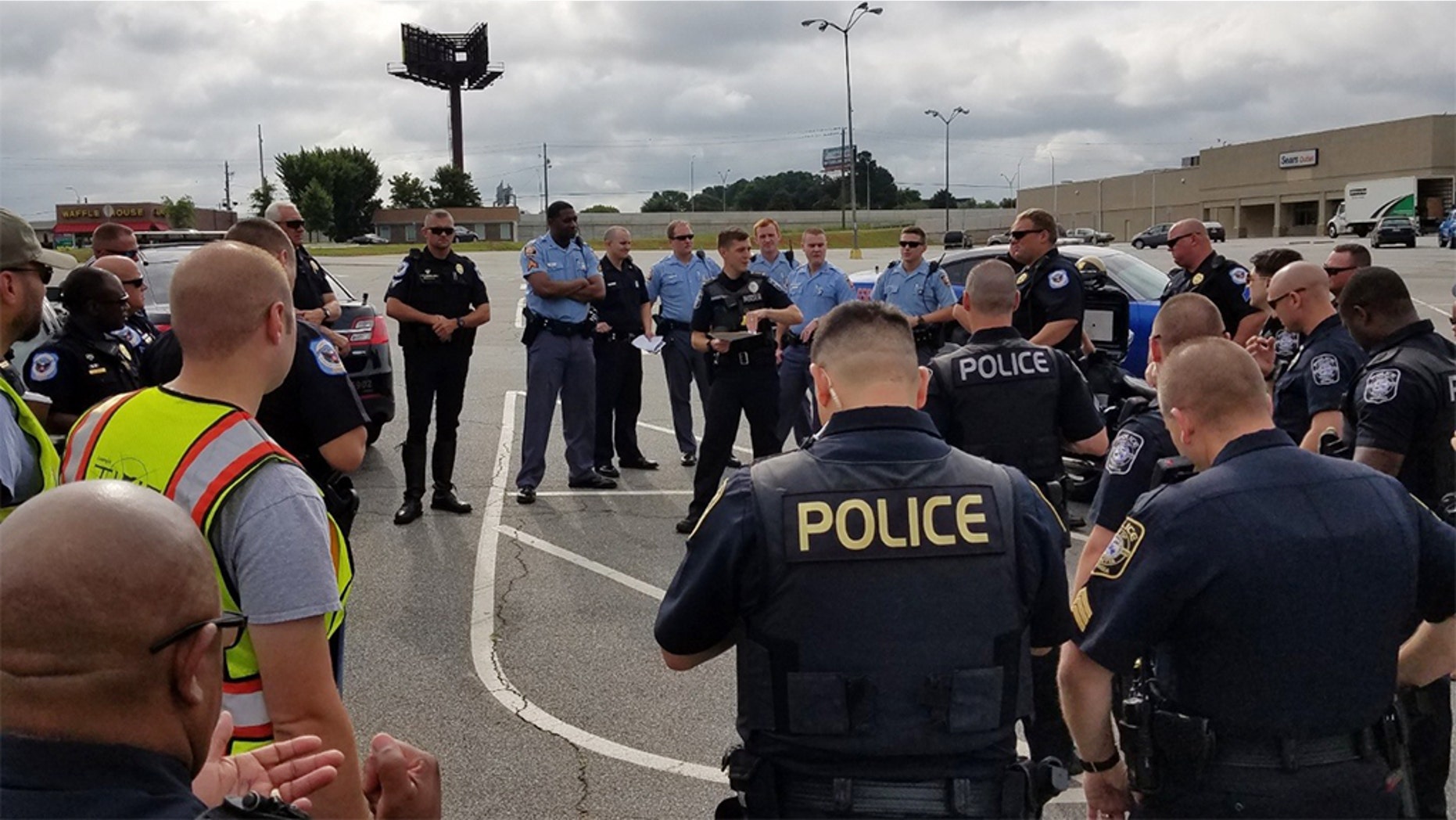 Law enforcement in Georgia posed as construction workers Wednesday to seek drivers on their phones or not wearing a seat belt near a busy intersection. (Marietta Police Department)
