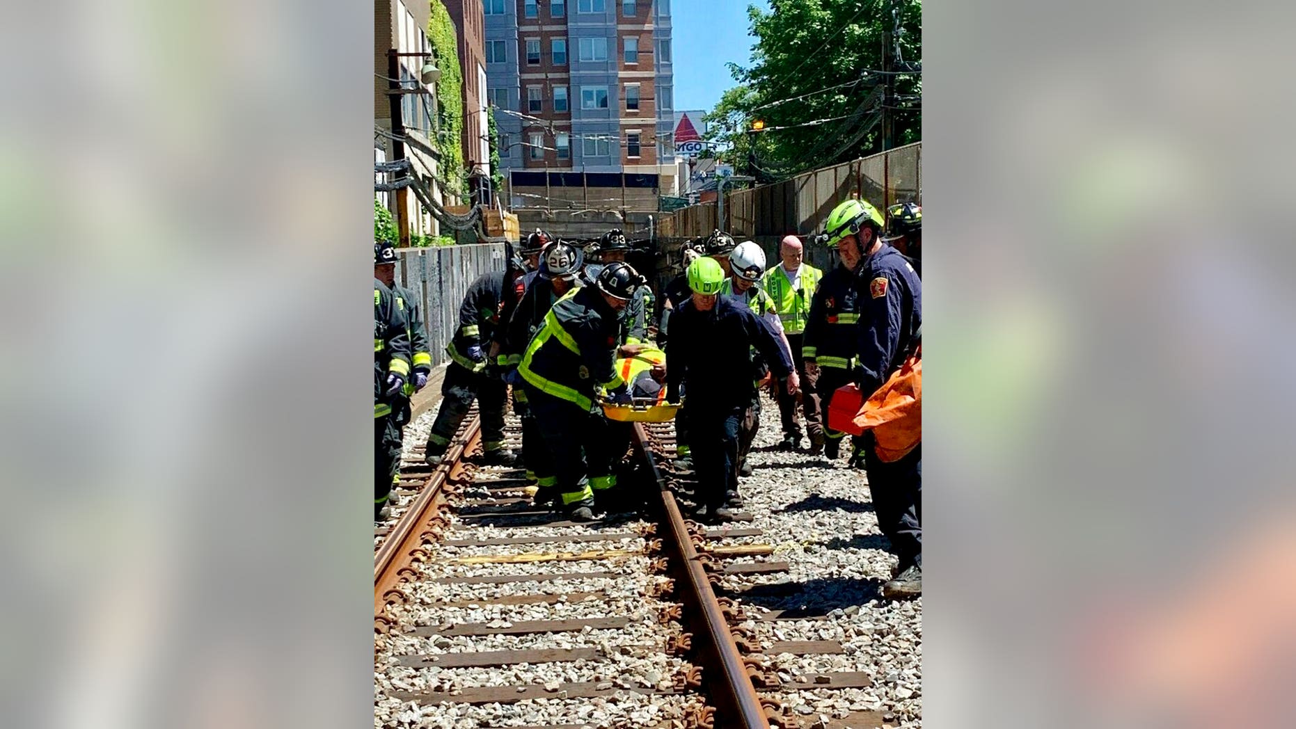 This photo provided by the Boston Fire Department, Firefighters and EMT personnel carry an injured person after a train car derailed in Boston on Saturday. Officials with the Massachusetts Bay Transportation Authority said the accident occurred at about 11 a.m. Saturday when a Green Line subway car derailed in a tunnel near Kenmore Square. Officials said several people were injured but none of the injuries are life-threatening. The cause of the derailment is under investigation. (Boston Fire Dept. via AP)