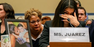 Yazmin Juárez reacts as a photo of her daughter, Mariee, who died after being released from detention by U.S. Immigration and Customs Enforcement, is placed next to her at a House Oversight subcommittee hearing on Civil Rights and Civil Liberties to discuss treatment of immigrant children at the southern border, Wednesday, July 10, 2019, on Capitol Hill in Washington. (AP Photo/Jacquelyn Martin)
