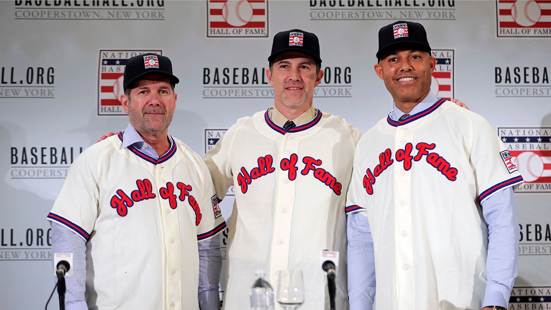 FILE - In this Jan. 23, 2019, file photo, Baseball Hall of Fame inductees Edgar Martinez, left, Mike Mussina, center, and Mariano Rivera, right, pose for photographs during news conference in New York. Baseball Hall of Fame induction ceremonies are on Sunday, July 21, 2019, in Cooperstown, N.Y. (AP Photo/Frank Franklin II)