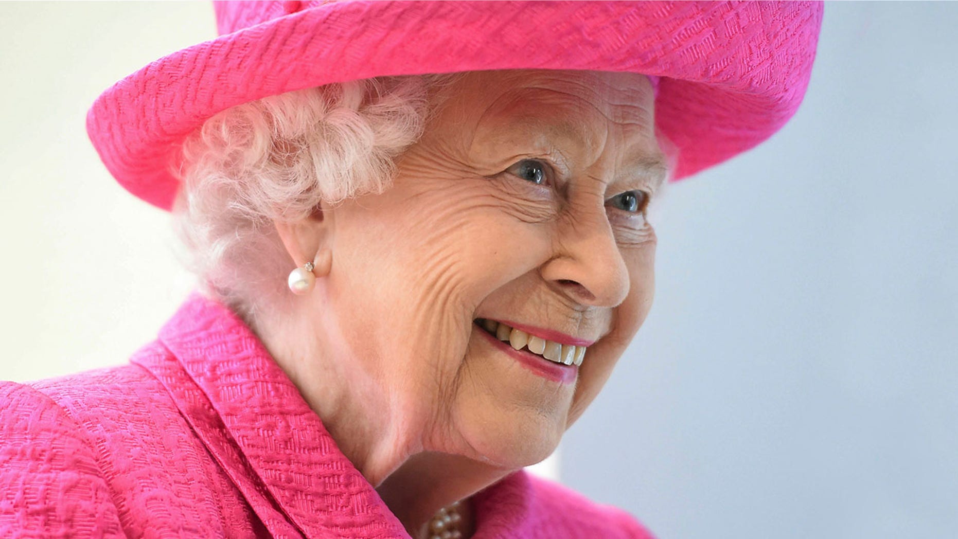 The Queen of England, Elizabeth II, reacts during a visit to the Royal Papworth Hospital in Cambridge, England on Tuesday, July 9, 2019. The Queen will visit some of the new state-of-the-art facilities during from his visit to the recently renovated Respiratory Fitness Center Royal Papworth Hospital. (Joe Giddens / PA via AP)