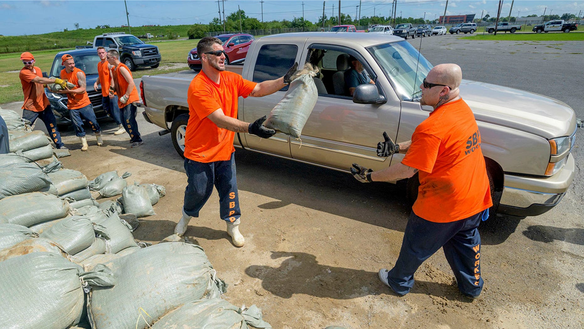 Employees at the St. Bernard Parish Sheriff's Office move free sandbags to residents of Chalmette, Louisiana on Thursday, July 11, 2019, in front of Tropical Storm Barry in the Gulf of Mexico. (AP Photo / Matthew Hinton)