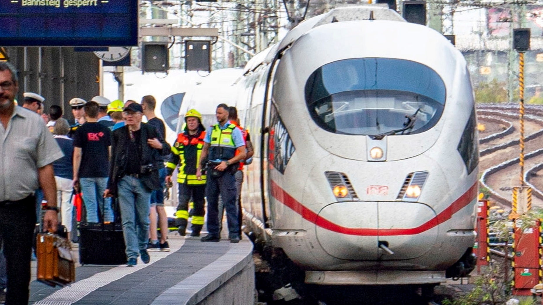 Firefighters and police officers remain on a high-speed ICE train at the main station in Frankfurt, Germany.