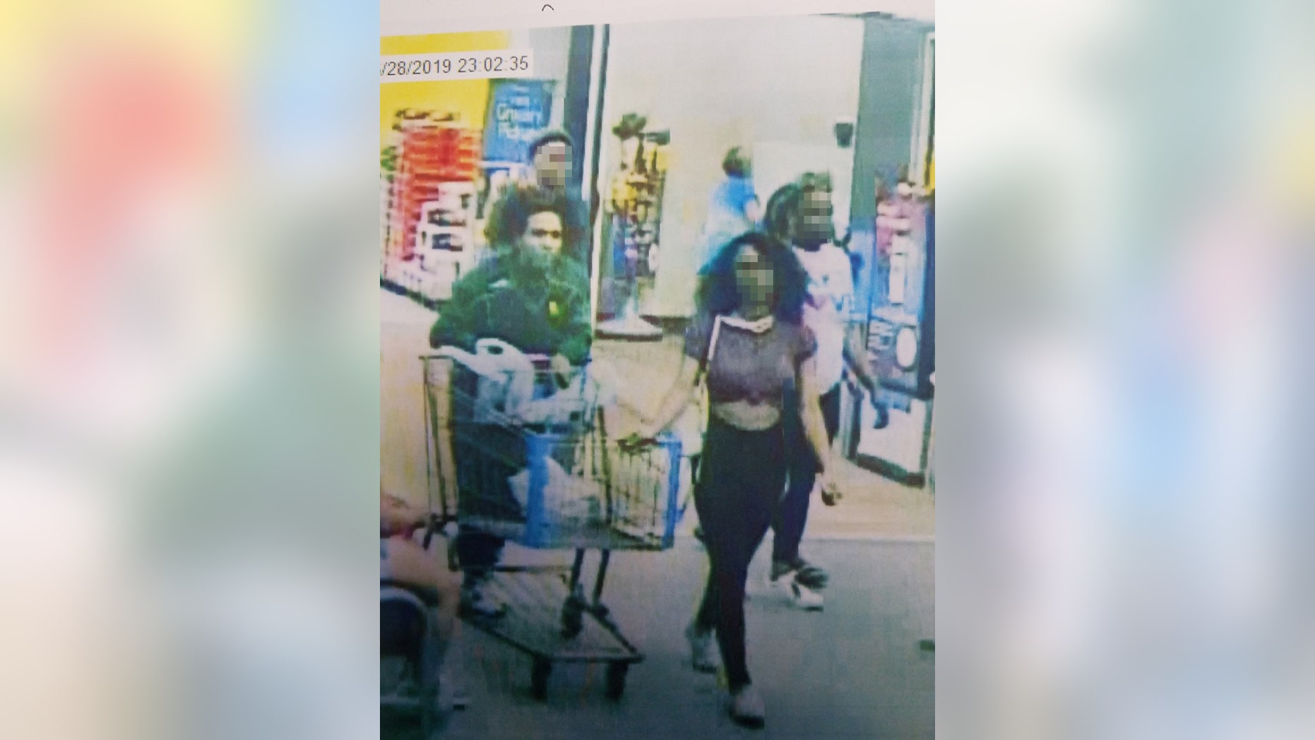 Still from store video showing the suspected "Blue Bell Licker" and her boyfriend. The girl, a juvenile whose name has not been released, has been identified by Lufkin, Texas police as the person who licked a tub of ice cream in a Walmart store then put it back in the freezer. 