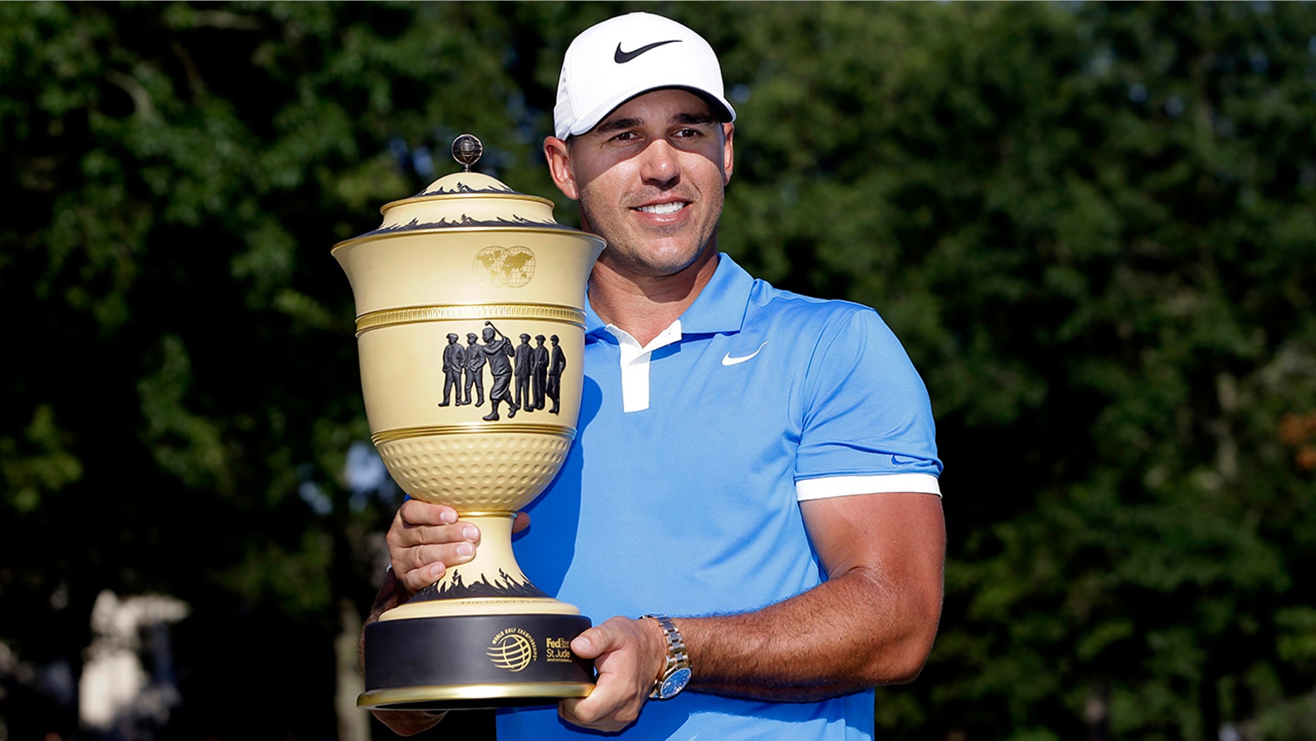 Brooks Koepka holds his trophy after winning the World Golf Championships-FedEx St. Jude Invitational Sunday, July 28, 2019, in Memphis, Tenn. (AP Photo/Mark Humphrey)
