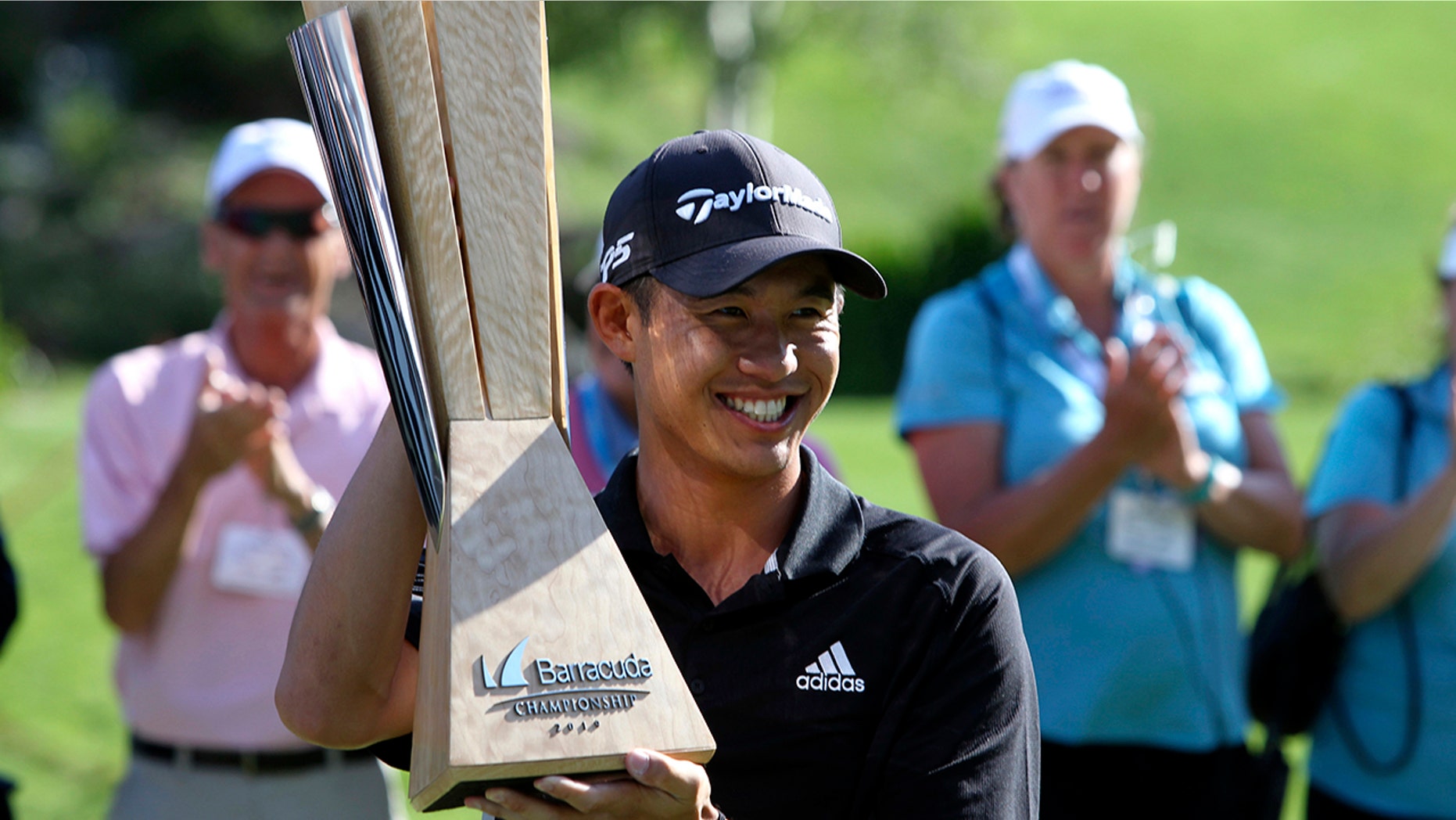Collin Morikawa holds up his trophy for the gallery after winning the Barracuda Championship golf tournament at Montreux Golf & Country Club in Reno, Nev., Sunday, July 28, 2019. (AP Photo/ Lance Iversen)