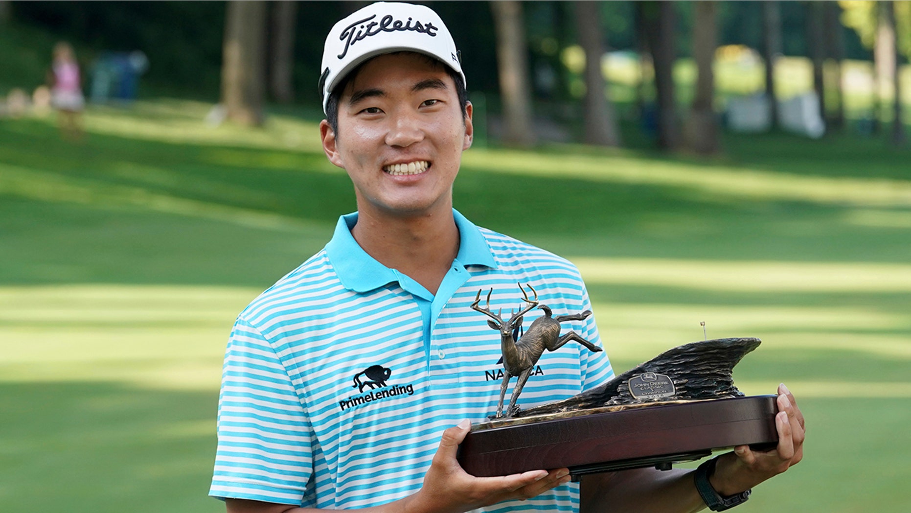 FILE - In this July 15, 2018, file photo, Michael Kim holds the trophy after winning the John Deere Classic golf tournament in Silvis, Ill. Kim had missed six out of seven cuts and changed coaches when he showed up at the John Deere Classic last year. He broke the tournament record at 27-under 257 and won by eight shots, matching Dustin Johnson and Francesco Molinari for the largest victory margin of the season. And then it was as if the week never happened. (AP Photo/Charlie Neibergall, File)