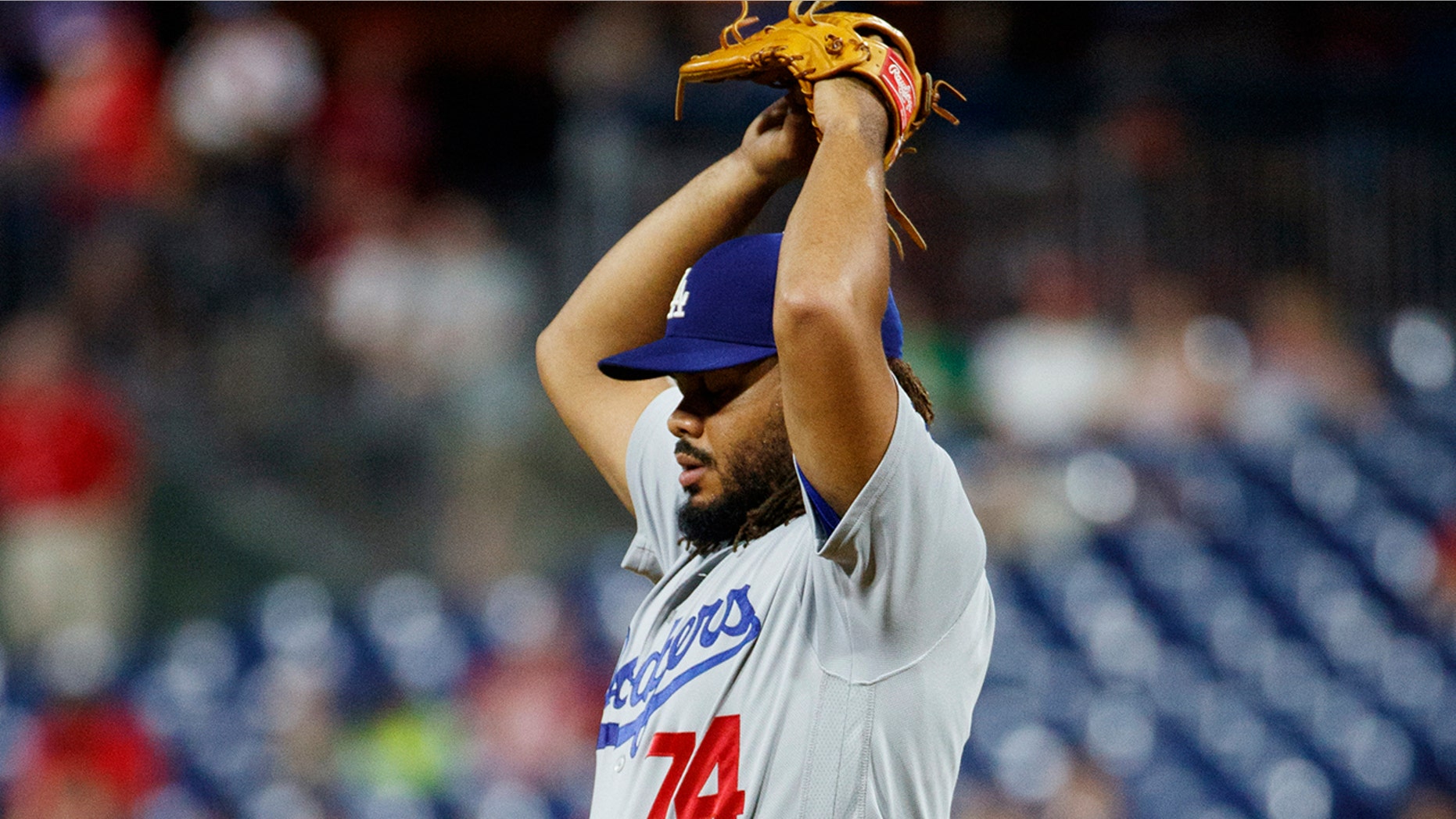 Los Angeles Dodgers relief pitcher Kenley Jansen stretches during the ninth inning of the team's baseball game against the Philadelphia Phillies, Tuesday, July 16, 2019, in Philadelphia. Philadelphia won 9-8. (AP Photo/Matt Slocum)
