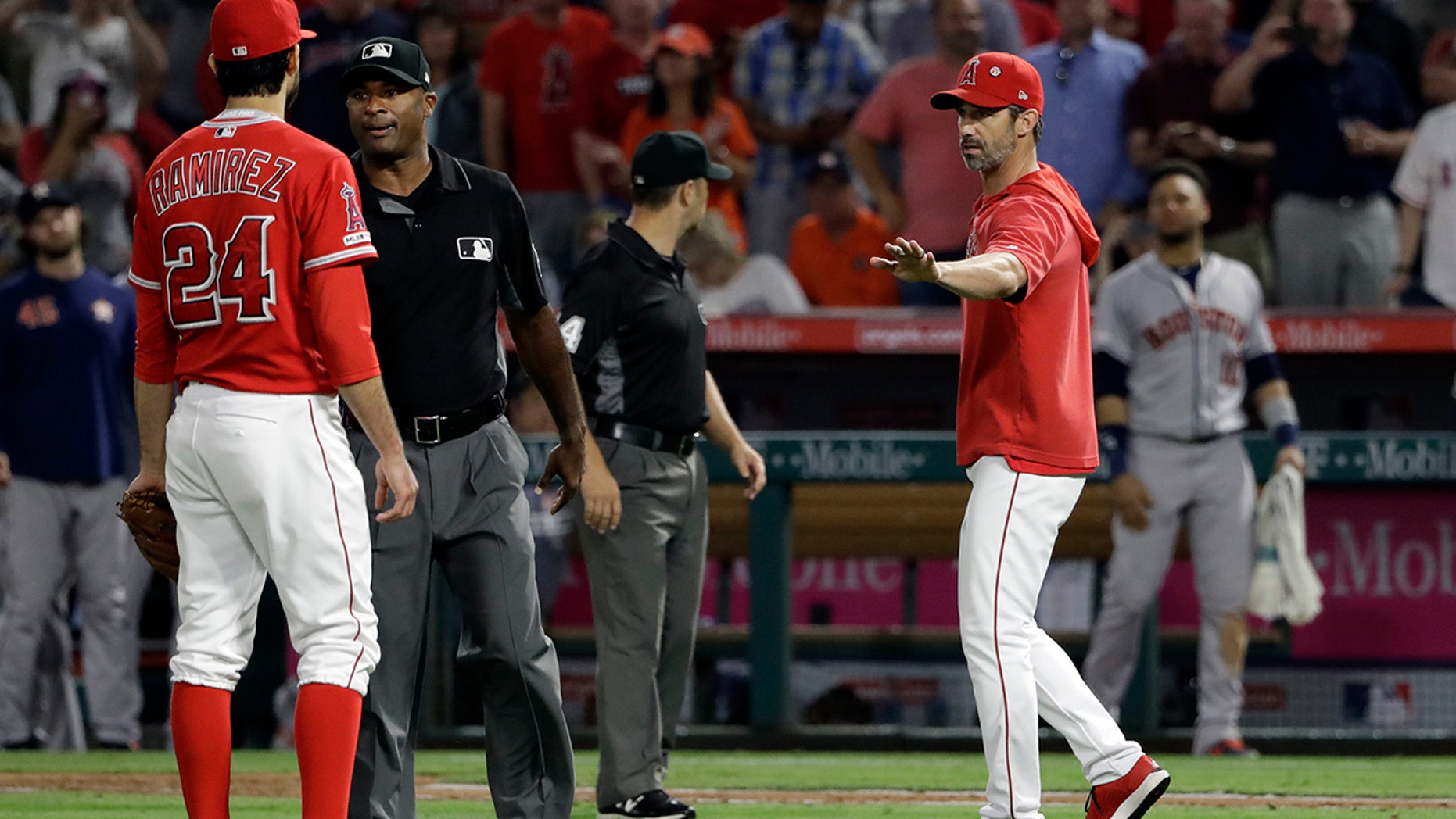 Los Angeles Angels manager Brad Ausmus right, gestures to pitcher Noe Ramirez (24) after Ramirez hit Houston Astros' Jake Marisnick with a pitch during the sixth inning of a baseball game Tuesday, July 16, 2019, in Anaheim, Calif. (AP Photo/Marcio Jose Sanchez)