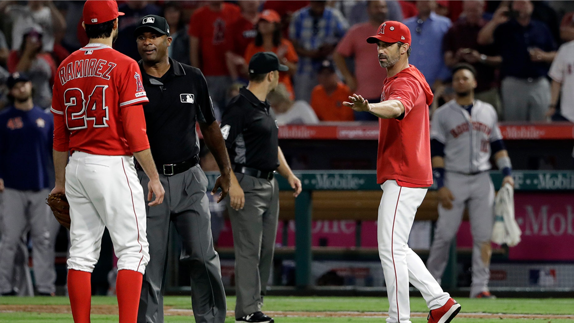 Los Angeles Angels manager Brad Ausmus right, gestures to pitcher Noe Ramirez (24) after Ramirez hit Houston Astros' Jake Marisnick with a pitch during the sixth inning of a baseball game Tuesday, July 16, 2019, in Anaheim, Calif. (AP Photo/Marcio Jose Sanchez)