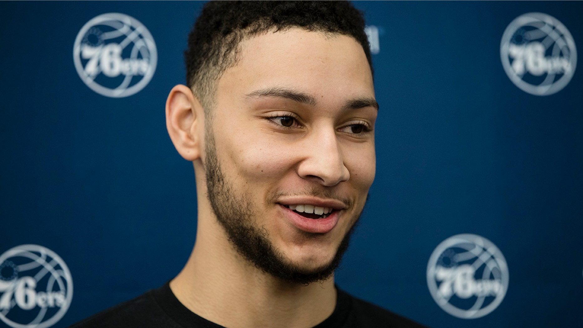 FILE - In this April 13, 2017, file photo, Philadelphia 76ers' Ben Simmons speaks with members of the media at the team's NBA basketball training facility in Camden, N.J. A person familiar with the situation says the Philadelphia 76ers and star guard Ben Simmons have agreed to a $170 million, five-year contract extension. The max deal is the latest big commitment by the team. The person spoke to The Associated Press on condition of anonymity Monday, July 15, 2019, because the contract is not official. (AP Photo/Matt Rourke, File)