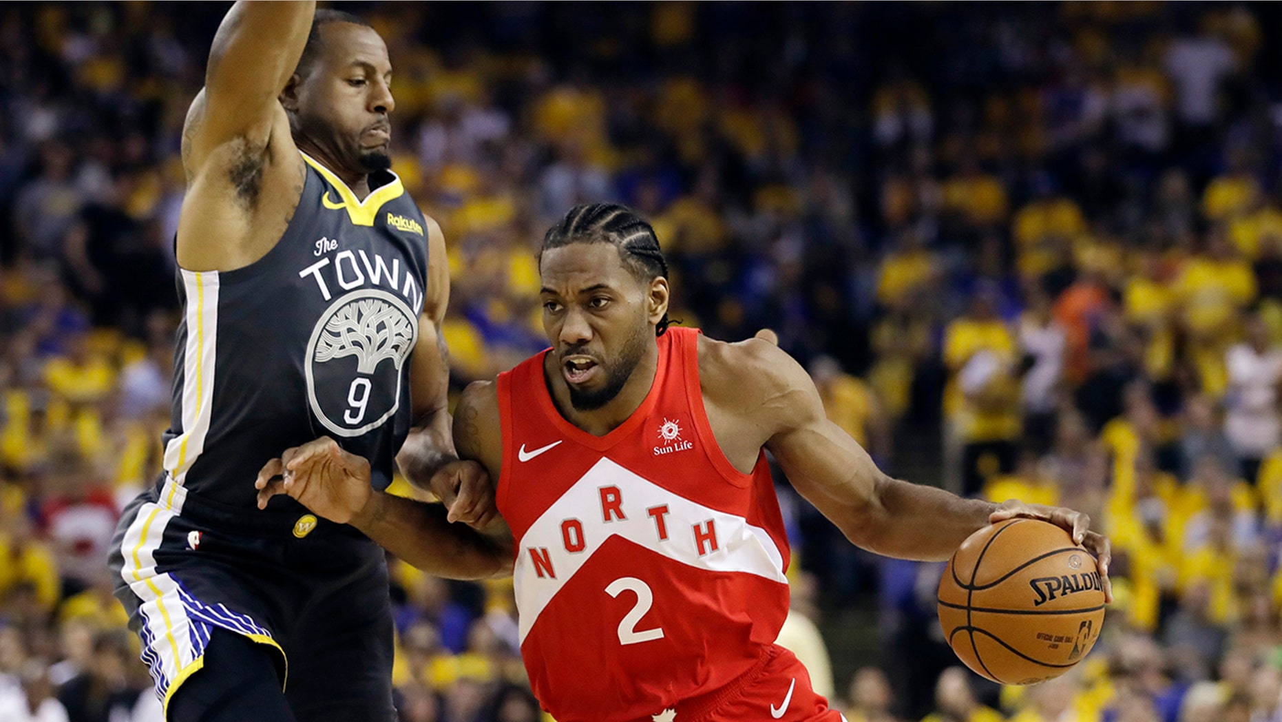FILE - In this June 13, 2019, file photo, Toronto Raptors forward Kawhi Leonard (2) drives against Golden State Warriors forward Andre Iguodala (9) during the first half of Game 6 of basketball's NBA Finals in Oakland, Calif. A person familiar with the negotiations says the Los Angeles Clippers will be landing Kawhi Leonard as a free agent after they acquire Paul George from the Oklahoma City Thunder in a massive trade for players and draft picks. (AP Photo/Ben Margot, File)
