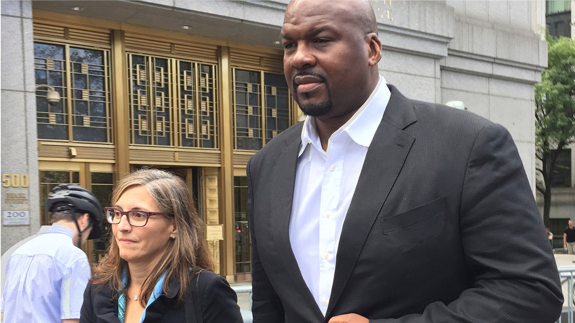 FILE - In this Oct. 10, 2017 file photo Chuck Person leaves Manhattan federal court in New York, after an initial appearance before a magistrate judge. Lawyers for the former Auburn University assistant basketball coach say the 13-year NBA veteran was broke and financially desperate when he joined a bribery conspiracy that cheated young athletes. They asked a judge in papers filed Tuesday, July 2, 2019 in Manhattan federal court to spare him from prison in the scandal that touched some of the biggest schools in college basketball. (AP Photo/Larry Neumeister, File)