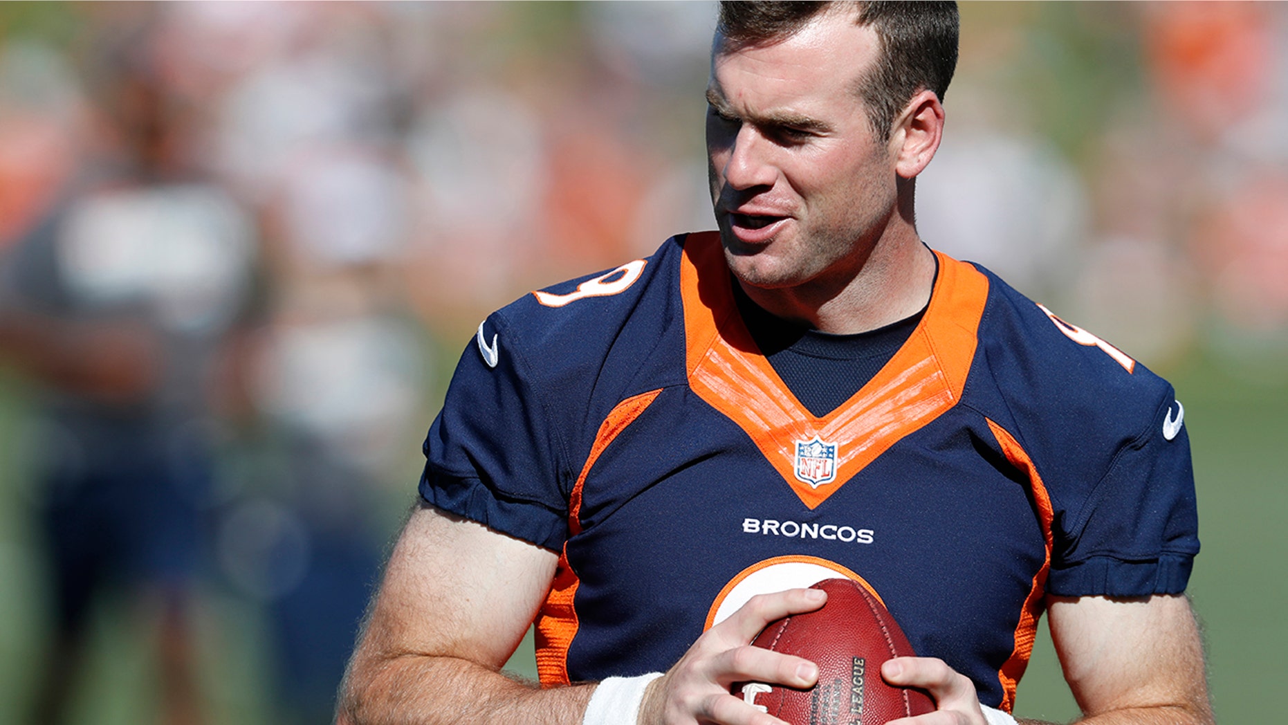 Denver Broncos quarterback Kevin Hogan looks to pass the ball during drills at the team's NFL football training camp Friday, July 19, 2019, in Englewood, Colo. (AP Photo/David Zalubowski)