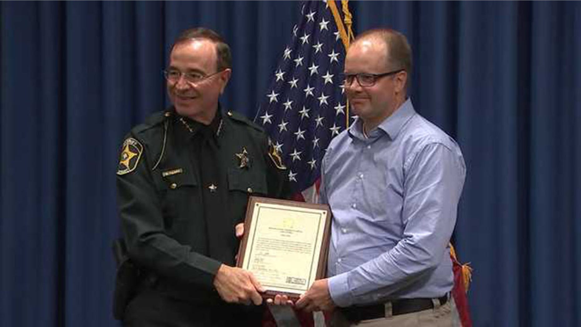 Ryan Petty, right, the father of a Parkland shooting victim Alaina Petty, became an honorary armed school guardian Thursday in Polk County.