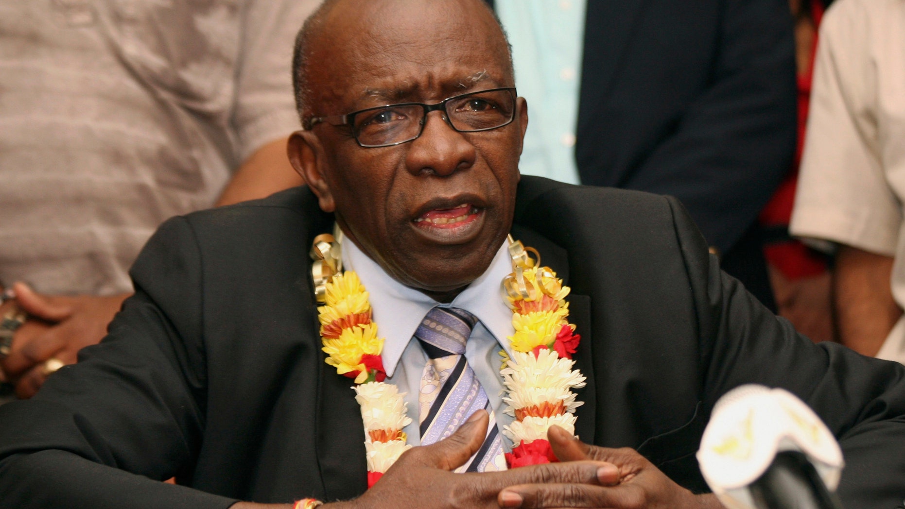 FILE - In this June 2, 2011, file photo, suspended FIFA executive Jack Warner gestures during a news conference at the airport in Port-of-Spain, Trinidad and Tobago. The former Caribbean soccer official has been ordered to pay a $79 million penalty stemming from the FIFA bribery scandal. A federal judge in New York City imposed the judgment against Warner in a lawsuit brought by the Confederation of North, Central American and Caribbean Association Football. (AP Photo/Shirley Bahadur, File)