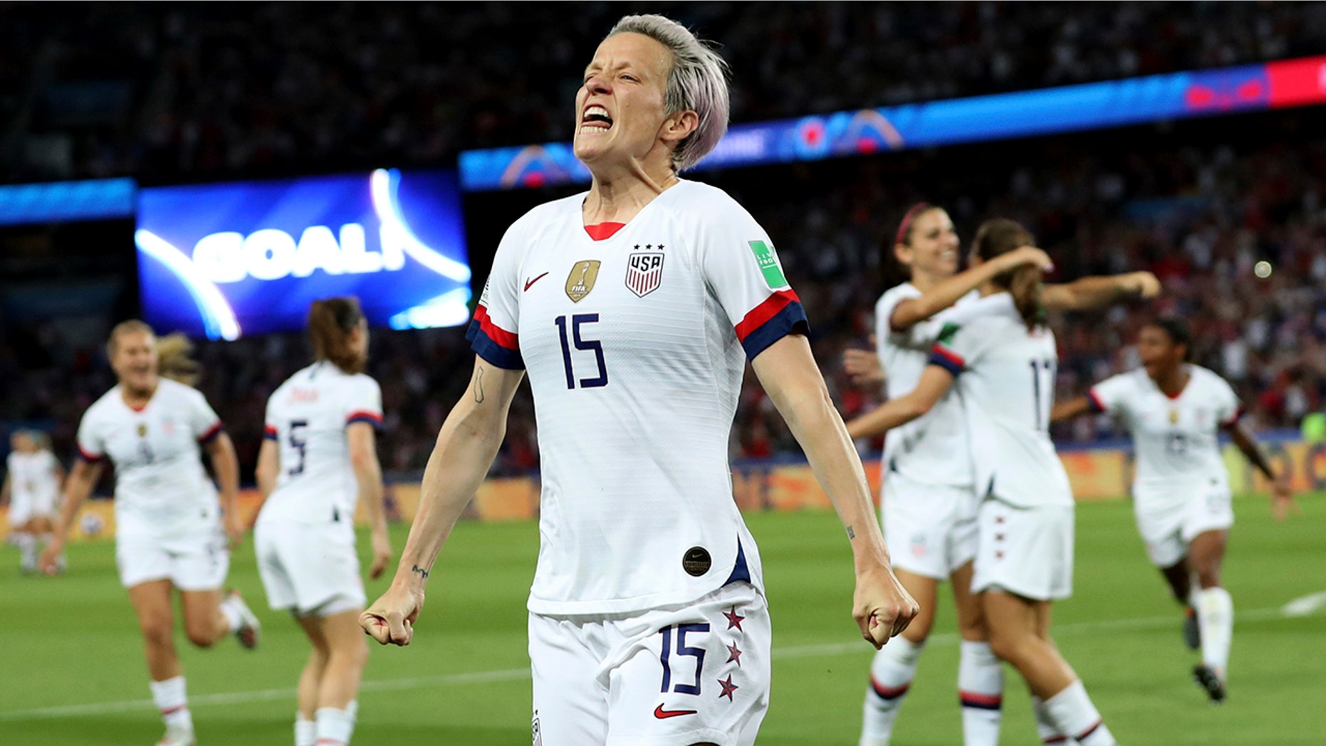 United States' Megan Rapinoe, center, celebrates after scoring her side's second goal during the Women's World Cup quarterfinal soccer match between France and the United States at the Parc des Princes, in Paris, Friday, June 28, 2019. (AP Photo/Francisco Seco)