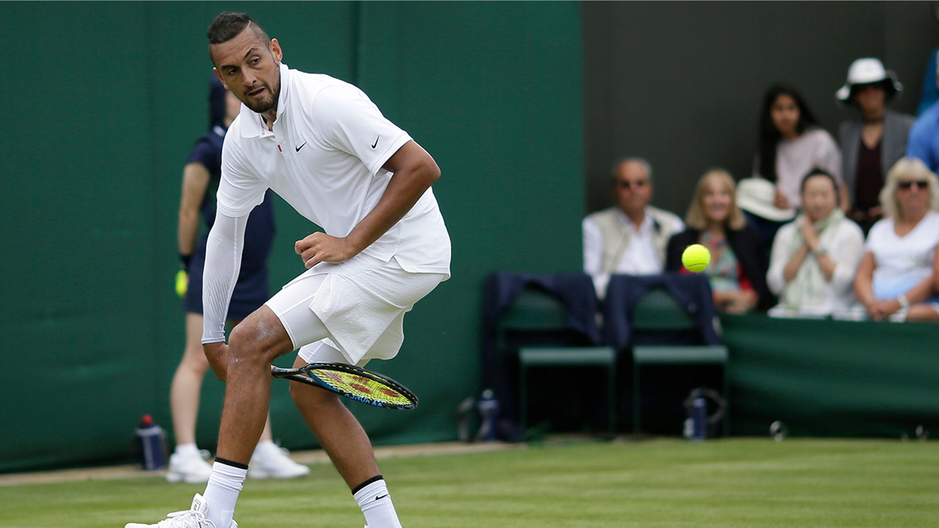 Australia's Nick Kyrgios returns the ball from between his legs to Australia's Jordan Thompson in a Men's singles match during day two of the Wimbledon Tennis Championships in London, Tuesday, July 2, 2019. (AP Photo/Tim Ireland)