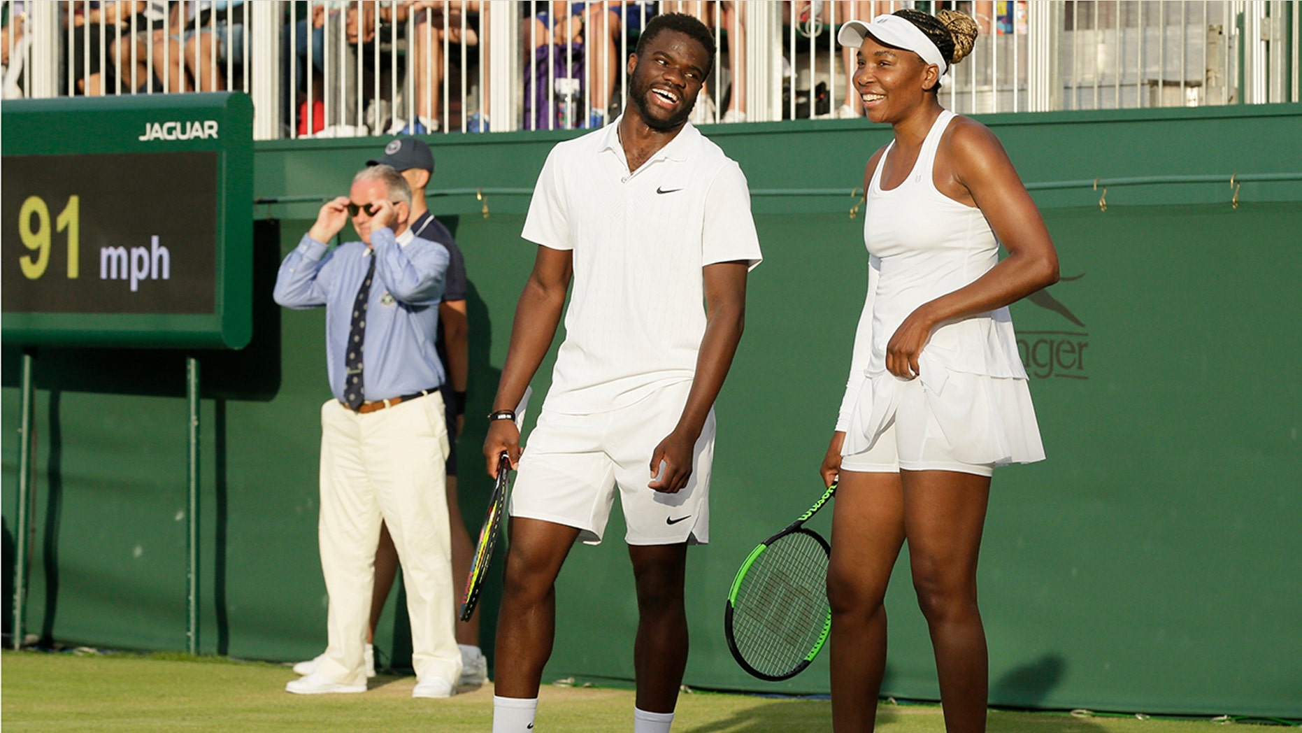 United States's Frances Tiafoe, left, and Venus Williams laugh during their Mixed Doubles match during day five of the Wimbledon Tennis Championships in London, Friday, July 5, 2019. (AP Photo/Tim Ireland)