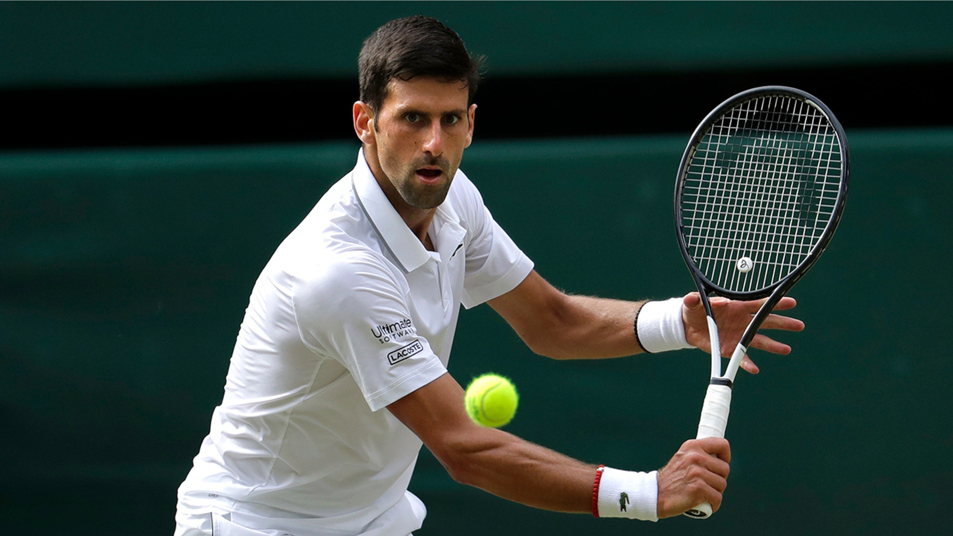 Serbian Novak Djokovic returns the ball to Swede Roger Federer in the final match of the Wimbledon Tennis Championship in London on Sunday 14 July 2019. (AP Photo / Ben Curtis)