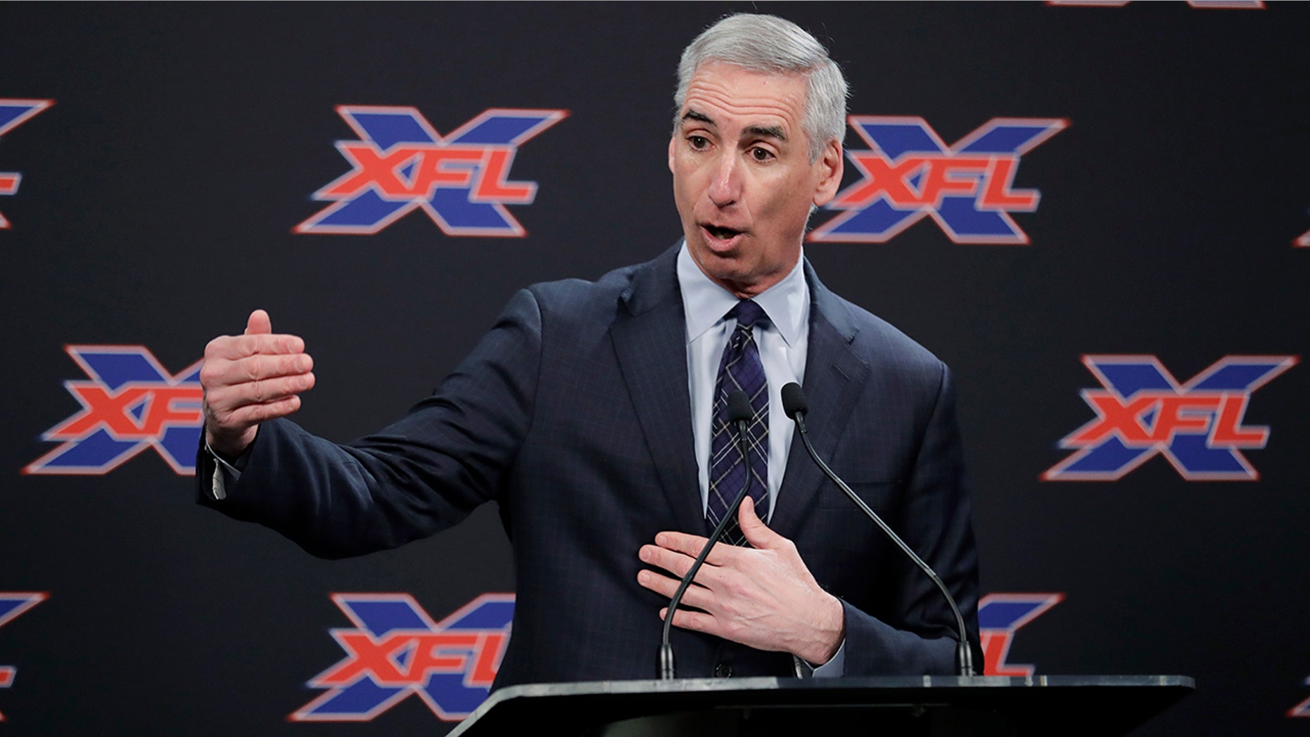 FILE - In this Feb. 25, 2019, file photo, XFL Football Commissioner Oliver Luck talks to reporters before introducing former NFL football quarterback Jim Zorn as the head coach for Seattle's XFL football team, in Seattle. Oliver Luck’s first year as the XFL’s commissioner has mostly been confined to the office and getting the league’s framework set up. The next couple months though are what Luck refers to as the fun part of preparing for next year’s return. (AP Photo/Ted S. Warren, File)