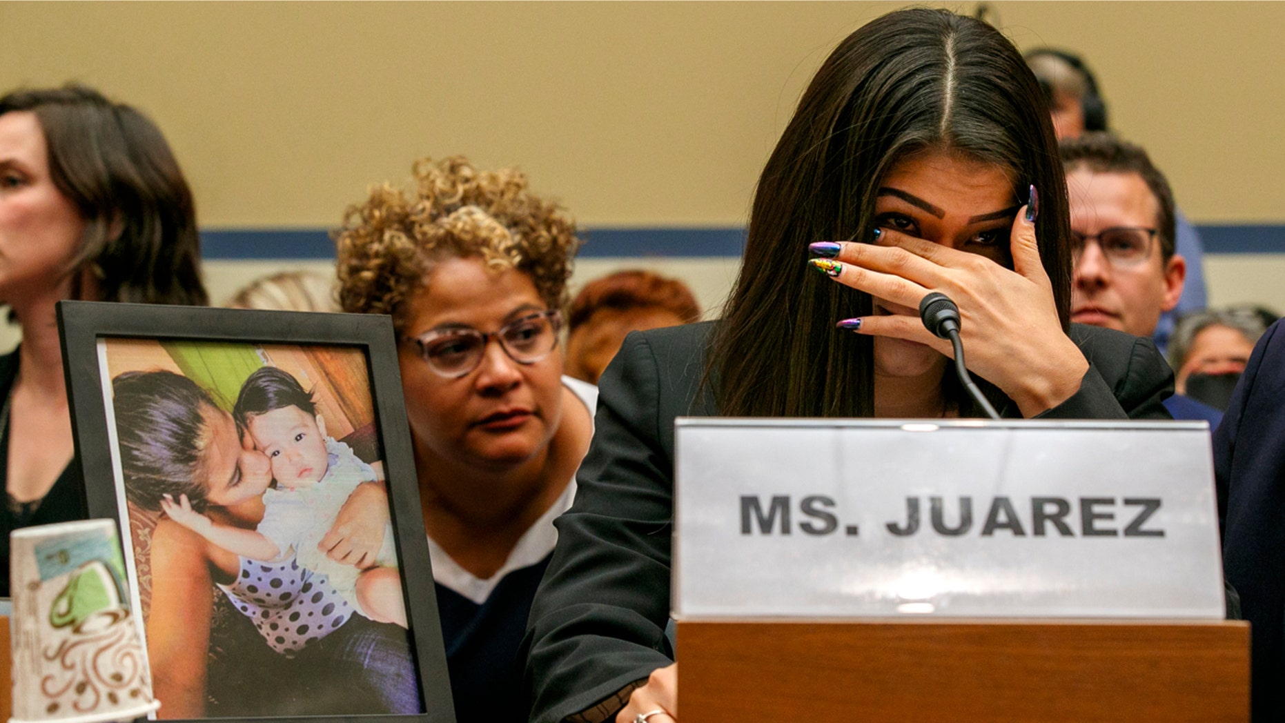 Yazmin Juárez reacts as a photo of her daughter, Mariee, who died after being released from detention by U.S. Immigration and Customs Enforcement, is placed next to her at a House Oversight subcommittee hearing on Civil Rights and Civil Liberties to discuss treatment of immigrant children at the southern border, Wednesday, July 10, 2019, on Capitol Hill in Washington. (AP Photo/Jacquelyn Martin)