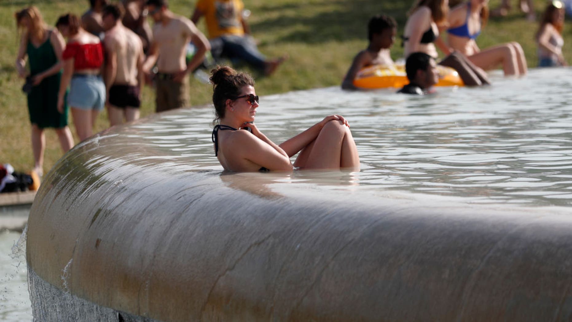 A woman sat in the Trocadero Fountain near the Eiffel Tower in Paris as temperatures in the city reached a record 113 degrees Fahrenheit (45 Celcius) on June 28.